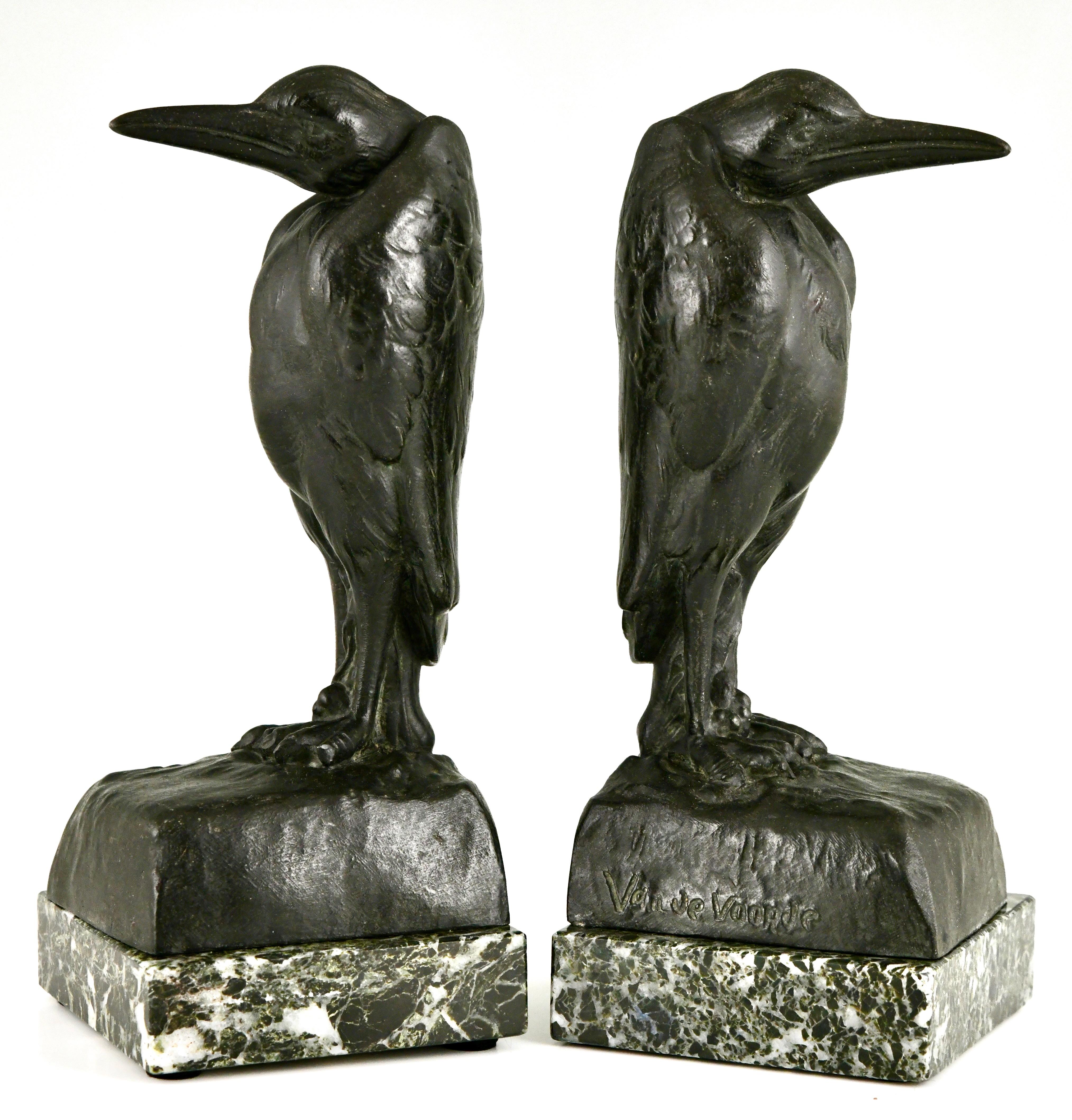 Art Deco Marabou bookends by Georges Van De Voorde with foundry mark. 
Patinated Art Metal on green marble base. 
France 1925. 
These bookends are illustrated on page 328 of 
Art Deco and other figures, Brian Catley, Antique collectors club.

 