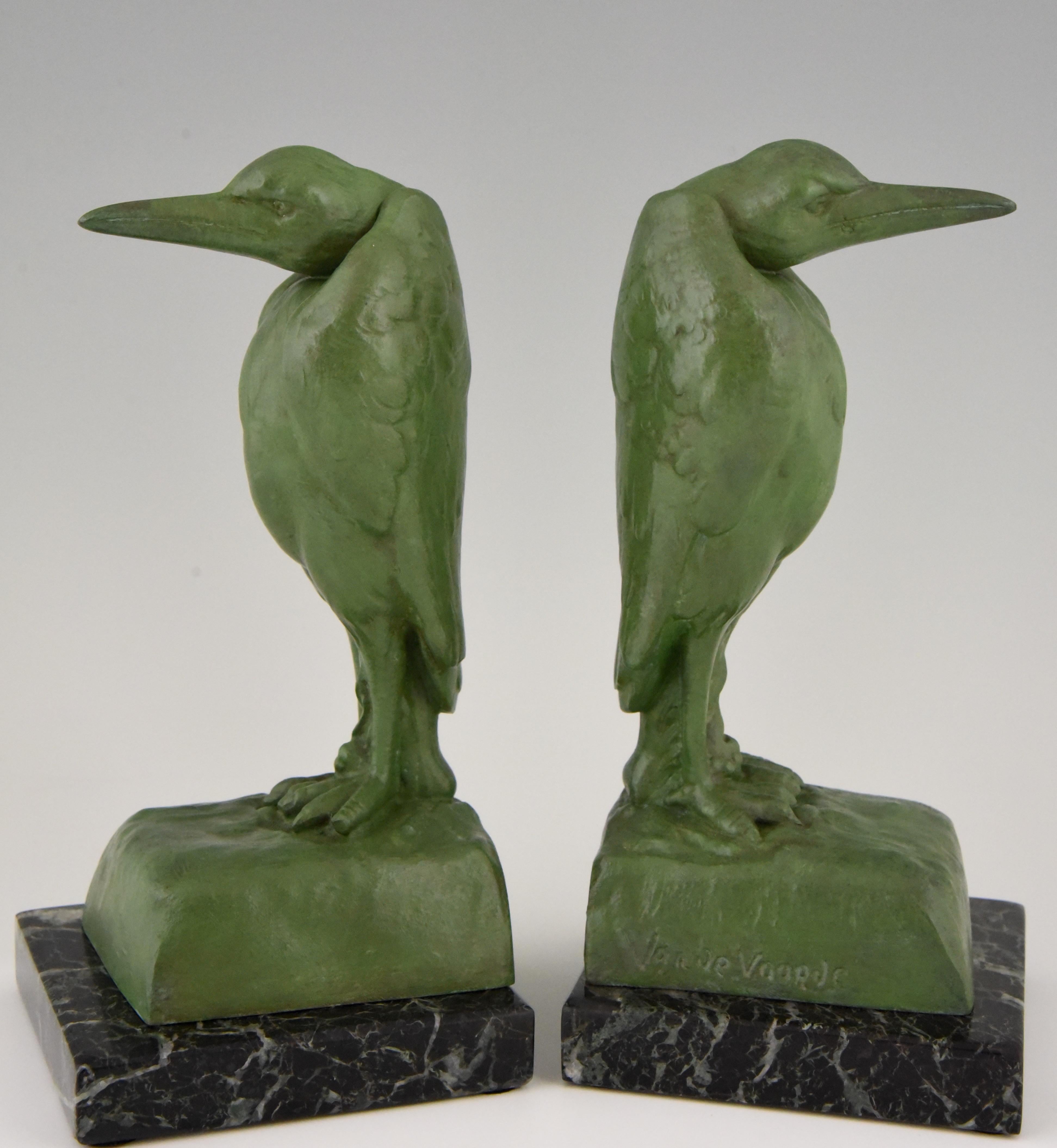 Very nice pair of Art Deco Marabou bookends by Georges Van De Voorde, a Belgian artist who worked in France, circa 1925. The bookends are in patinated art metal and stand on a green marble base.
These bookends are illustrated on page 328 of ?“Art