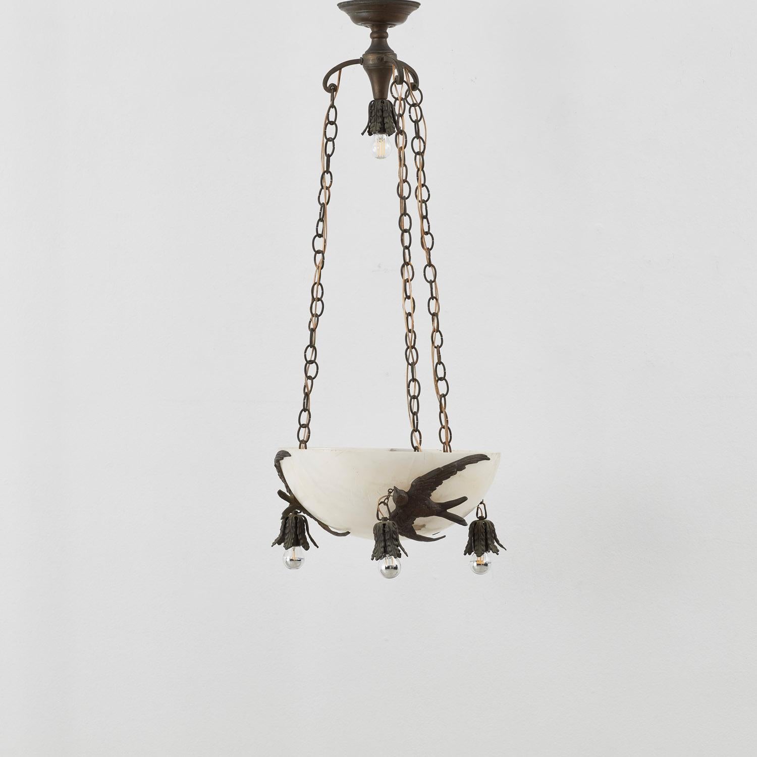 A decorative Art Deco pendant with a wonderful sense of theatre. The demi-lune marble shade is embellished with three ornate bronze birds, perhaps swifts, which are connected to foliage-style bronze fixtures.
