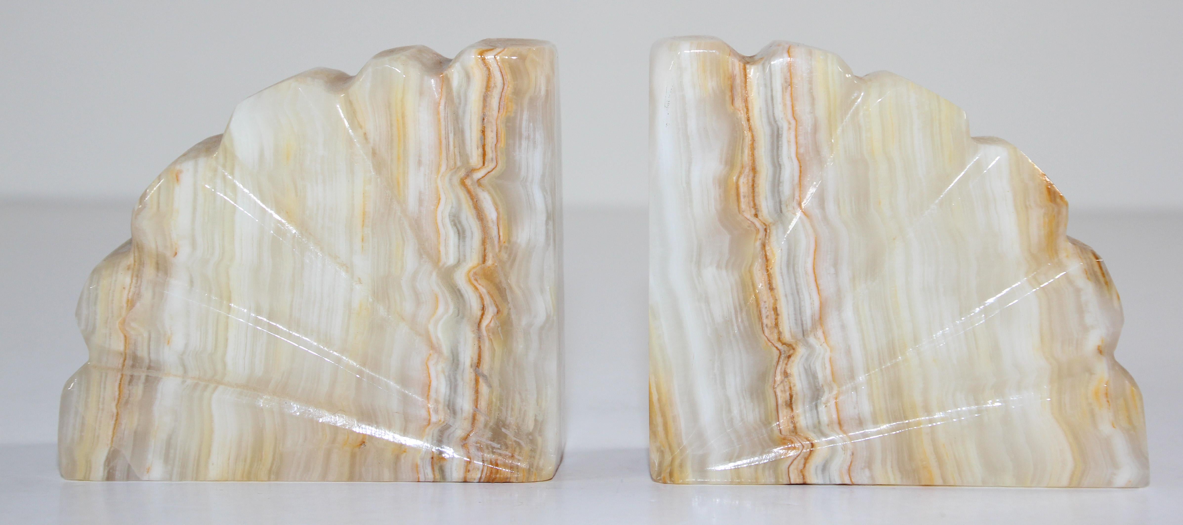 Hand carved marble book ends,
These are very substantial, heavy and well handmade bookends.
They are handmade creamy beige with auburn color. 
Hand carved and polished with the side supports carved as a stylized scallop shell with curved upper