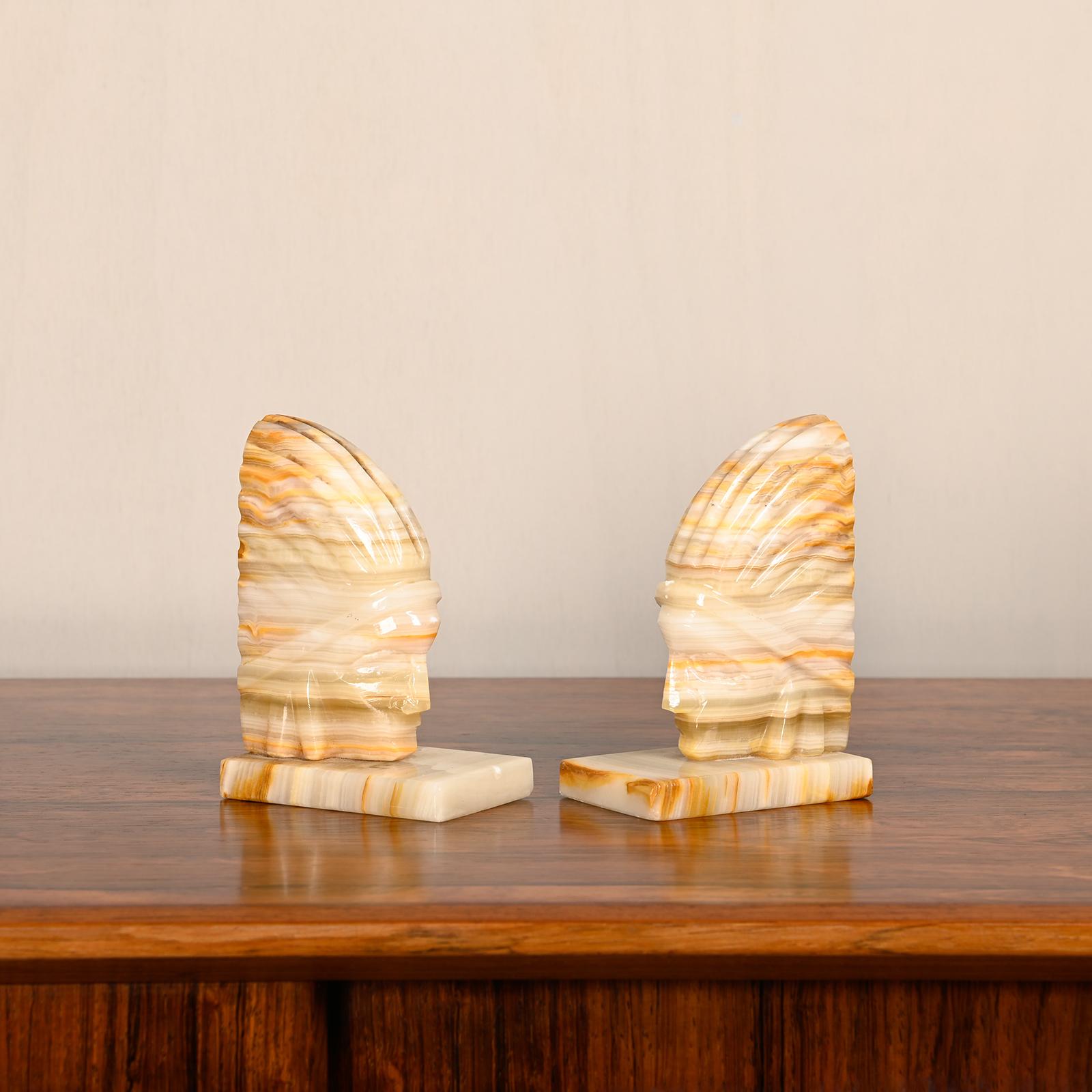 Art Deco marble bookends with carved heads of Native Americans. Good original condition with slight traces of use.