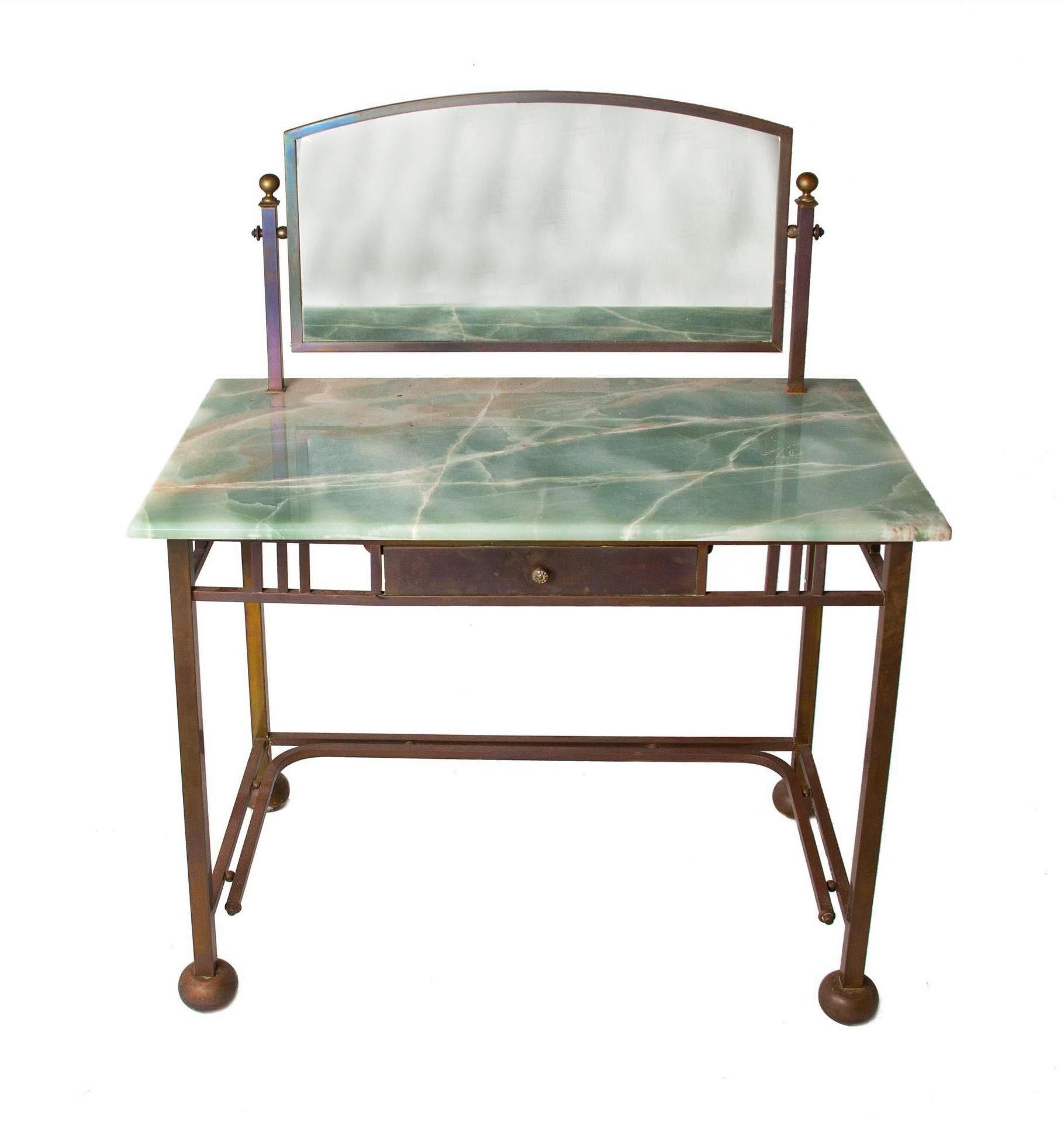 Rare Art Deco marble & brass dressing table with mirror made in France.

Brass hardware with pale green marble top and swivel mirror. Center drawer with brass face and knob measures 12 3/4
