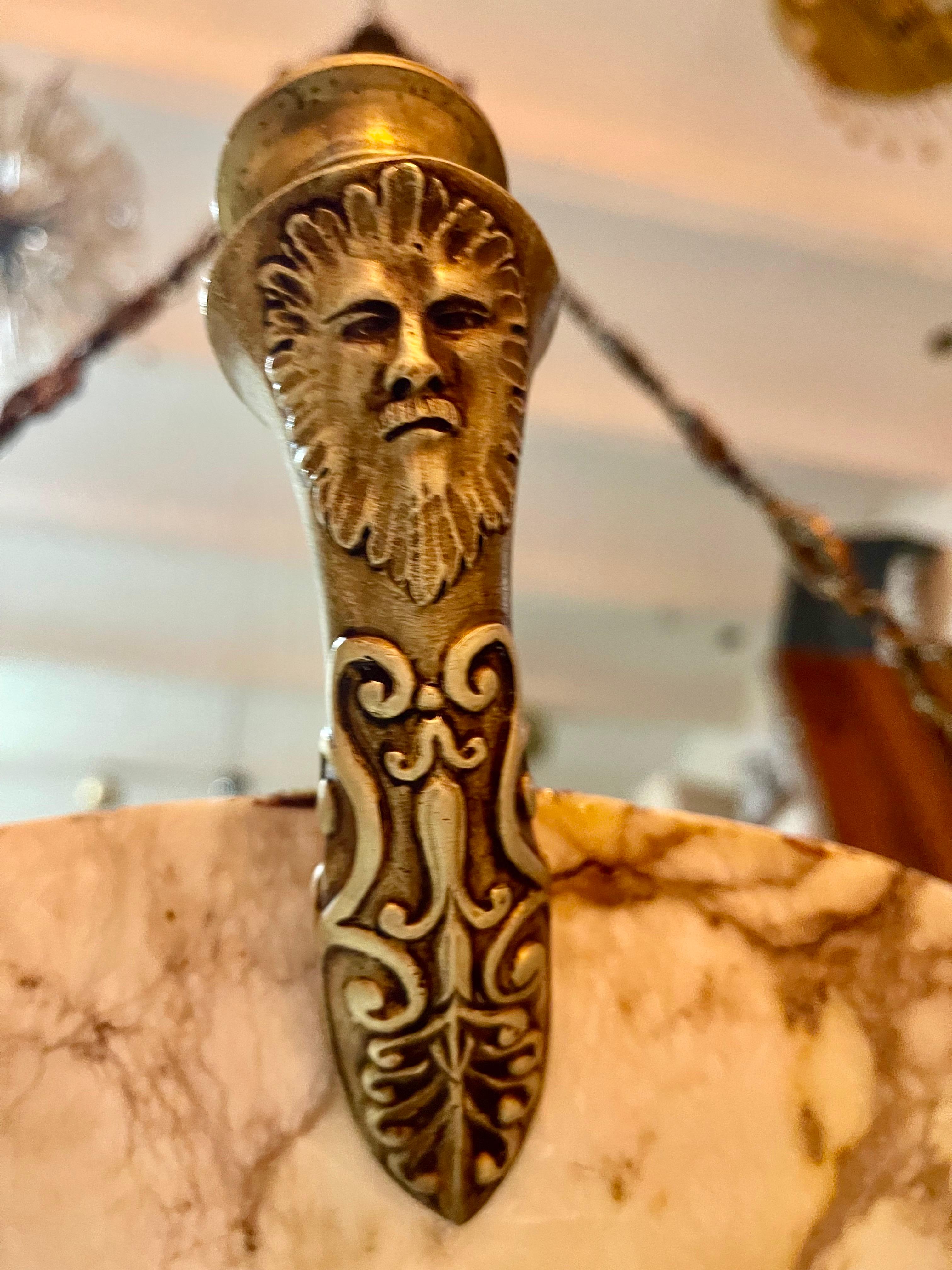 Art deco pendant light in black-veined white marble alabaster with full structure bronze fittings.
Adorable alabaster pendant light dating from the 1920s. This antique and magnificent white-veined alabaster bowl is suspended by four bronze massive