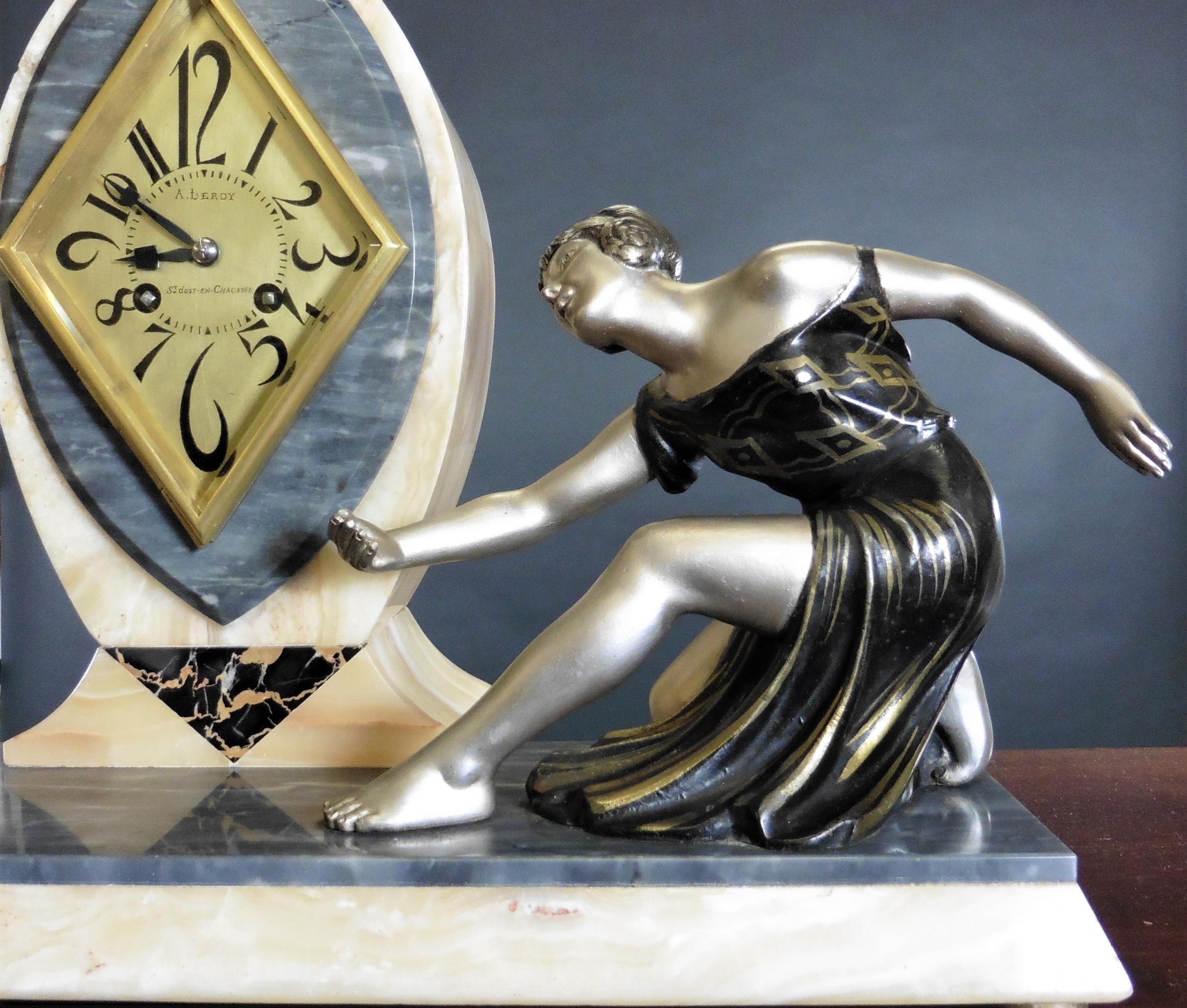 Art Deco mantel clock

Art Deco mantel clock standing on a cream and grey marble base resting on four brass bun feet supporting an ovoid shaped top housing a gilded diamond shaped bezel.

Gilded dial with Art Deco style numerals and original Art