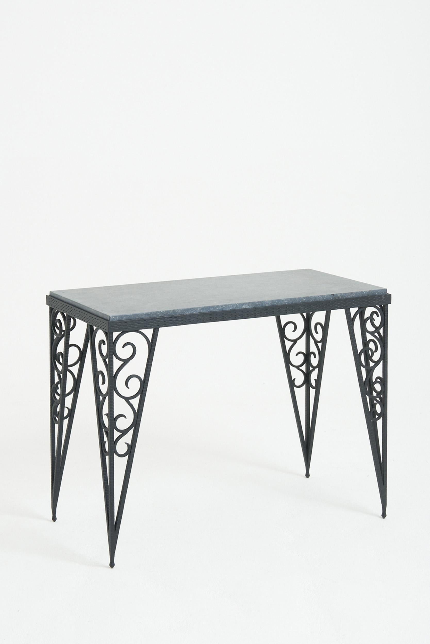 An Art Deco wrought iron console table, with a later Belgian fossil stone top.
France, Circa 1930
71 cm high by 90 cm wide by 45 cm depth
