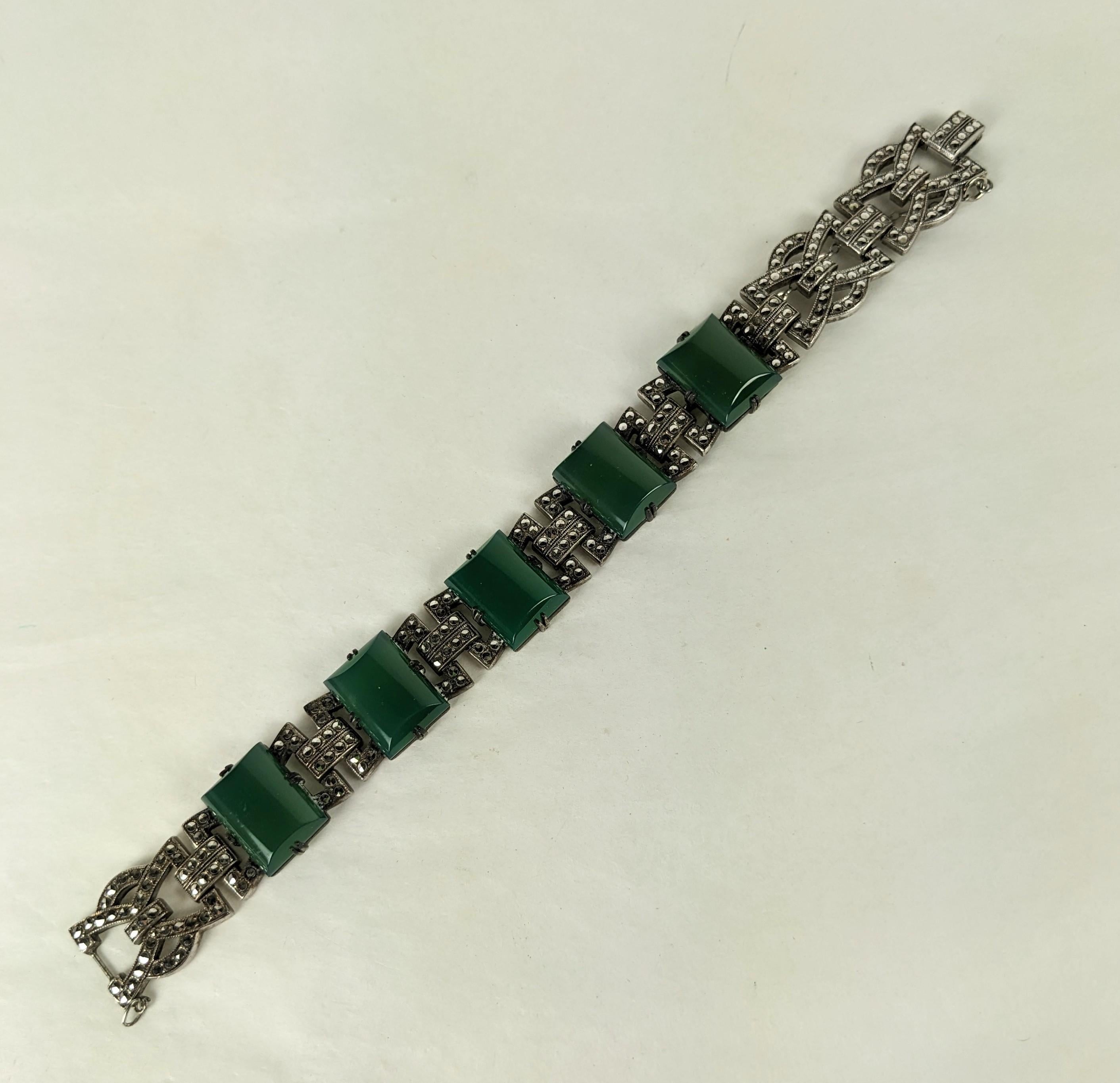 Lovely High Style Art Deco Marcasite Green Onyx Bracelet from the 1920's. Attractive pierce work design set with marcasites in sterling with a series of green onyx semi precious rectangular cabs. 
Wonderful quality, 7.5
