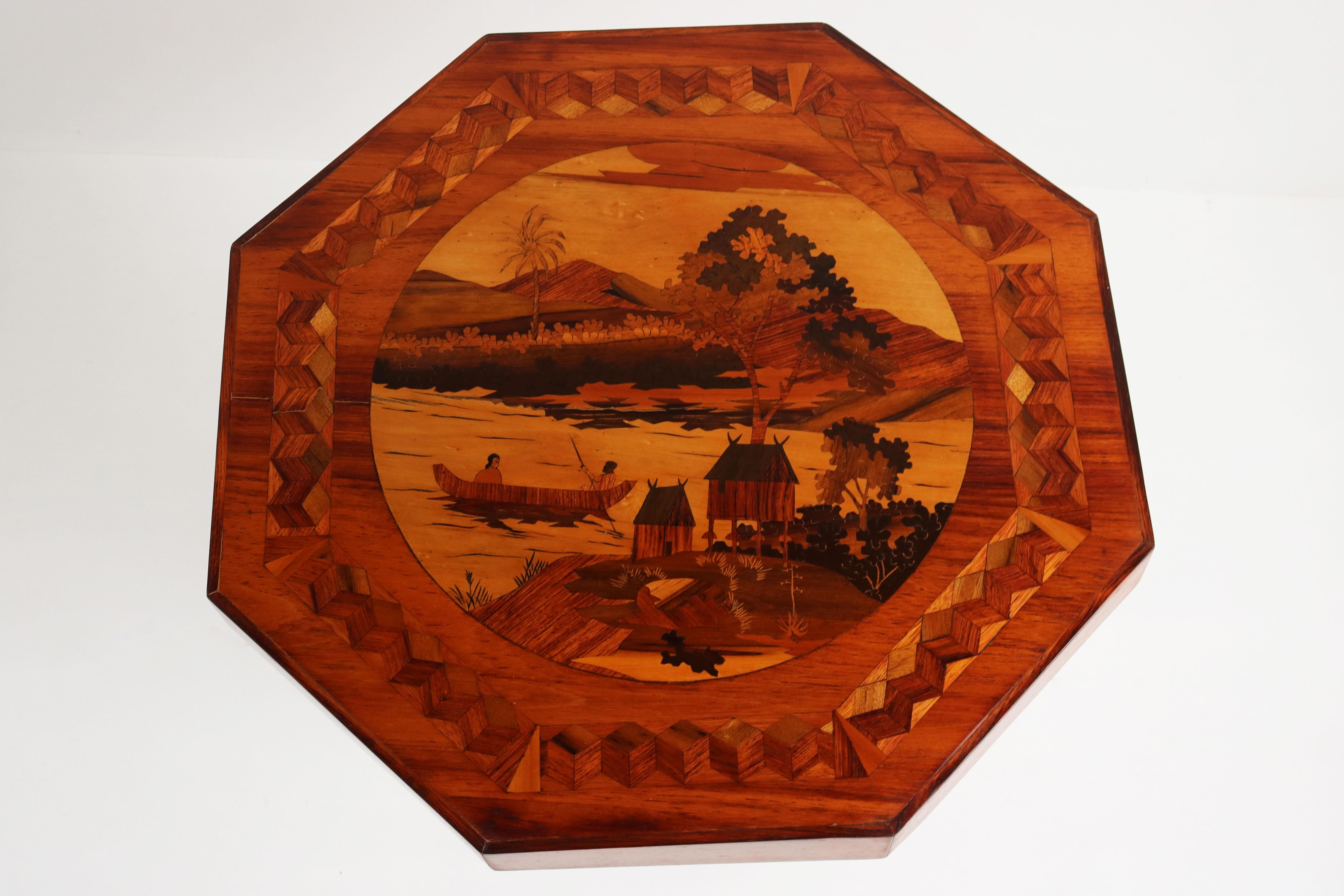 Marvelous French Art Deco octagonal table with superb Inlay 1930. 
This rare Art Deco piece is a stunning display of craftsmanship with numerous inlay decorations and period typical Octagonal shape. 
The table top displays an Oriental scenery very