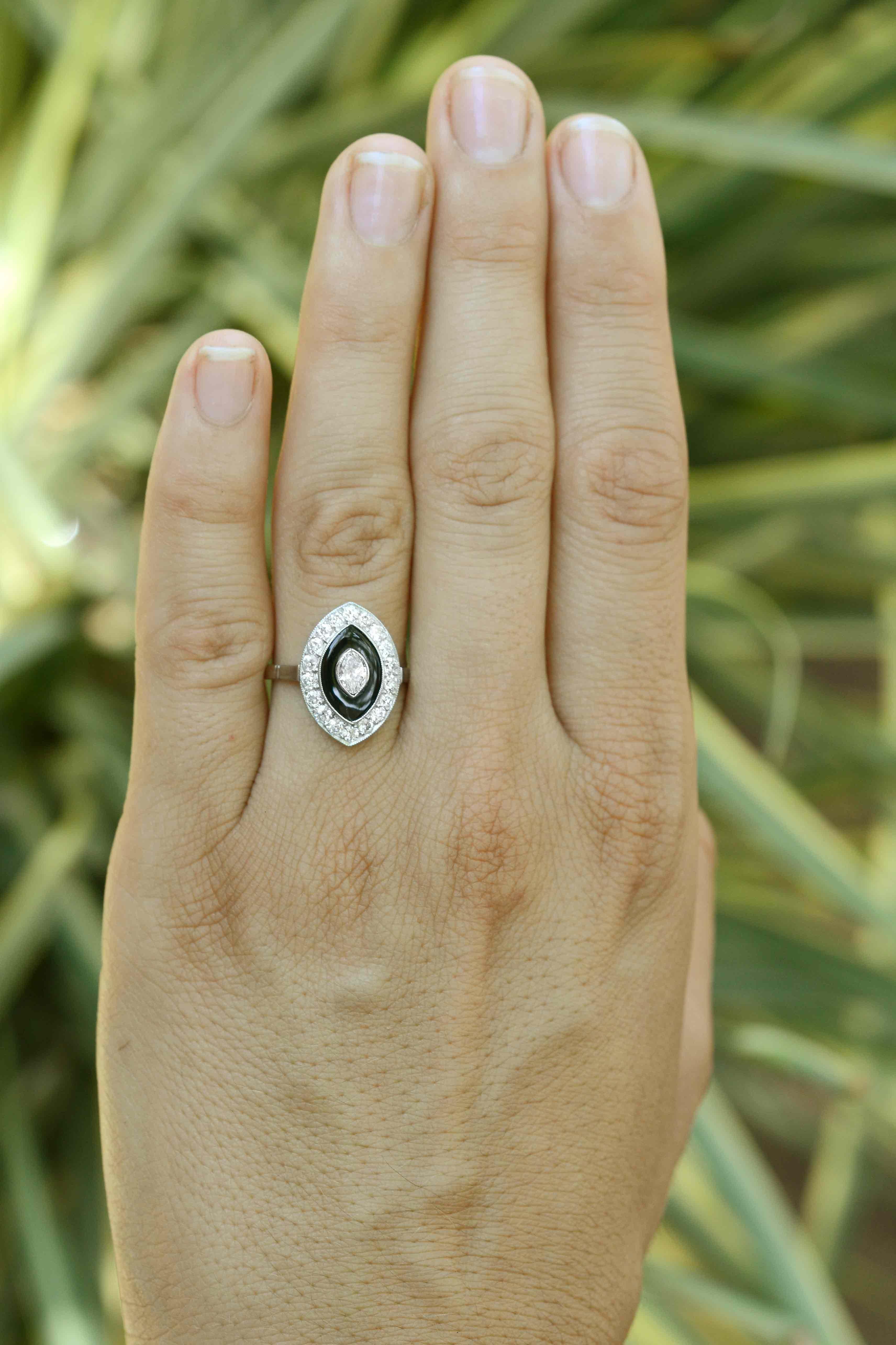 The Carlisle Hall Art Deco marquise diamond black onyx engagement ring is a sleek, Jazz Age cocktail ring with an evil eye motif. Centered by a sizzling, sparkling  center diamond cradled by a glistening black onyx and milgrain platinum halo and