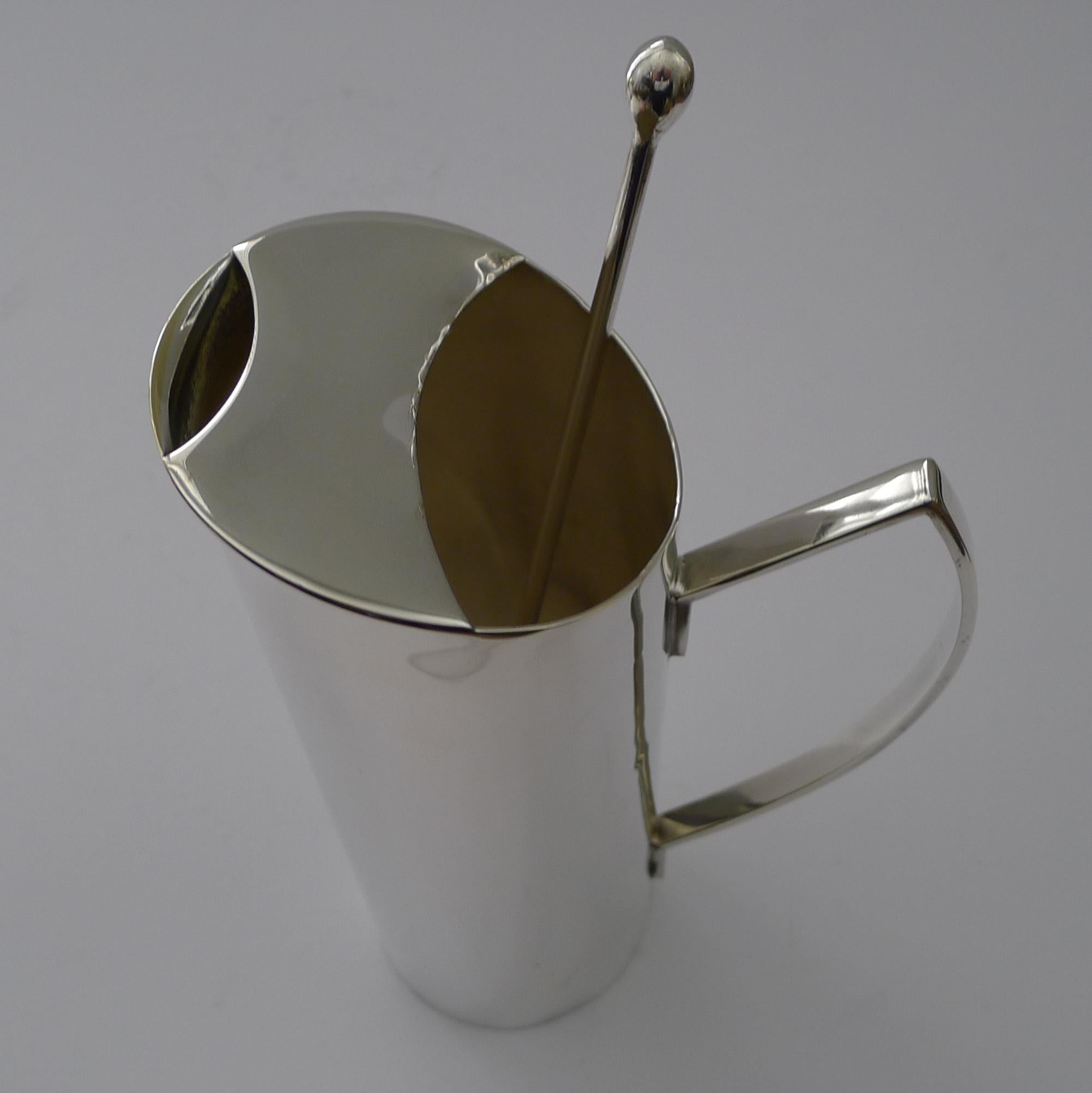 A stylish piece of vintage barware, dating back to the late Art Deco era, c.1940.

English in origin and made from silver plate, the jug retains the original long stirring spoon stamped 