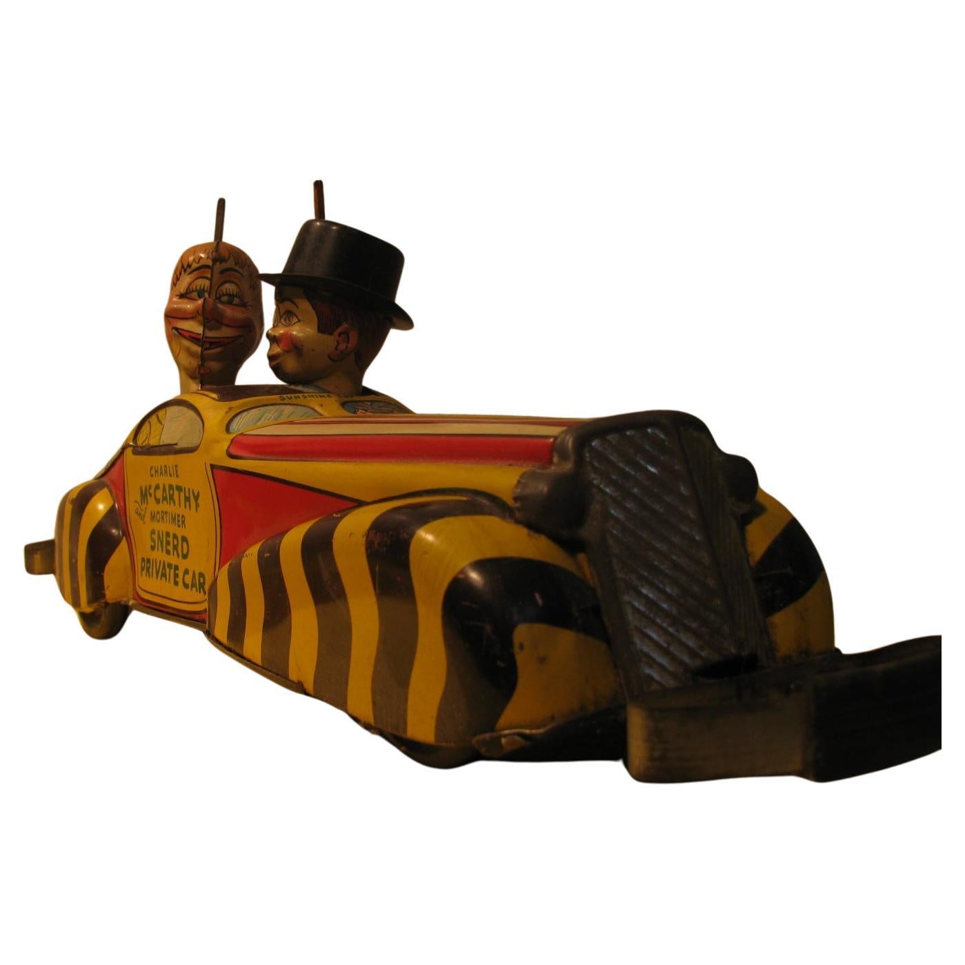 Fabulous tin litho car toy from Louis Marx, circa 1930. Fabulous paint with some paint chips and scrapes but no rust or dents. Clockwork mechanism works very well as the car races forward collides with something and automatically goes into reverse