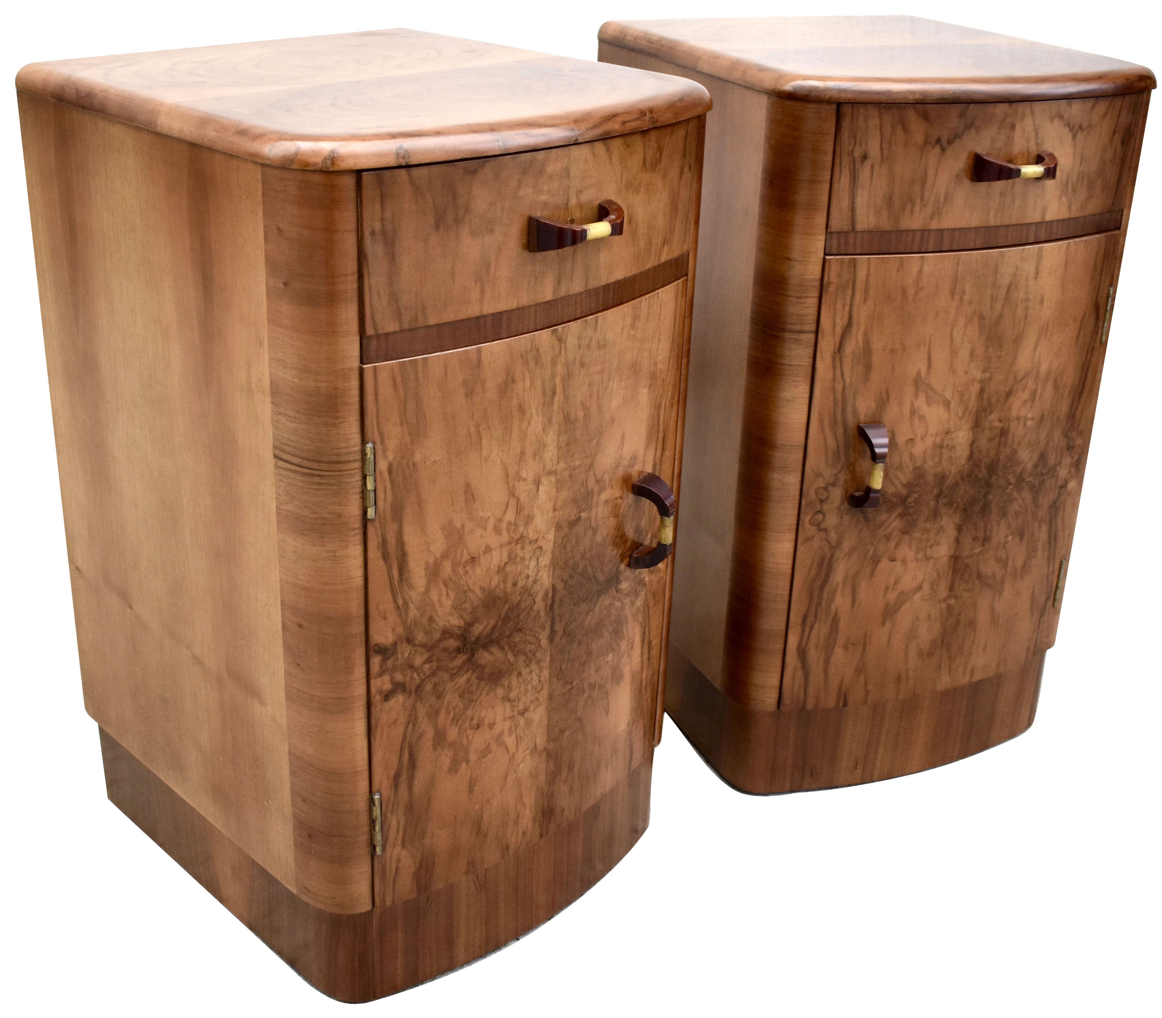 Fabulous pair of matching 1930s Art Deco bedside tables in heavily figured walnut veneer. Two generously sized internal storage areas. Each cabinet has a pullout / pull-out upper drawer which slides out effortlessly. We've had both cabinets fully