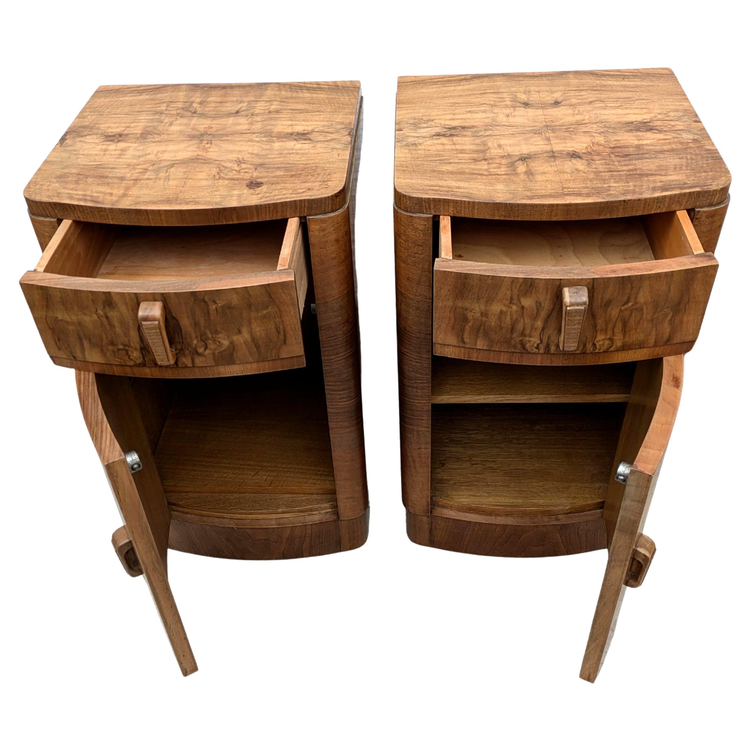 Fabulous pair of matching 1930s Art Deco bedside tables in heavily figured walnut veneer. Made in England. Two generously sized internal storage areas. Each cabinet has a upper drawer which works effortlessly. We've had both cabinets fully and