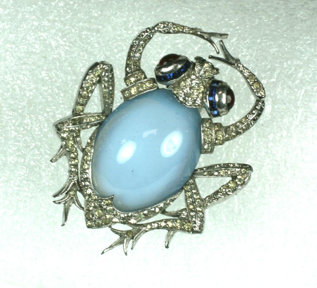 Art Deco Marcel Boucher Beetle Clip from the 1930's. Large faux moonstone belly with pave accents, faux sapphires and ruby cab eyes. Highest quality manufacture from the Art Deco Period.
1930's USA.  Excellent condition. Unsigned. 
2.5