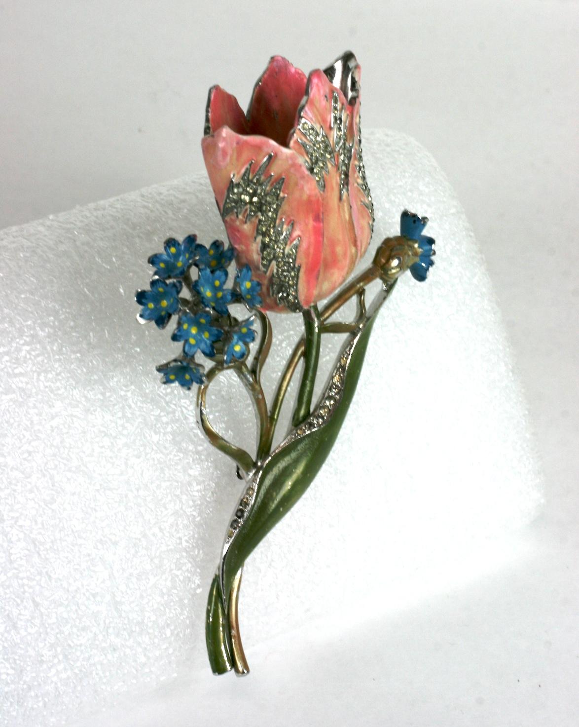 Large extraordinary Art Deco Mazer tulip and forget me knot bouquet brooch of pale peach pink and olive green pearlized cold enamel with accents of blue gloss cold enamel. The large tulip flower head further enhanced with fine crystal rhinestone