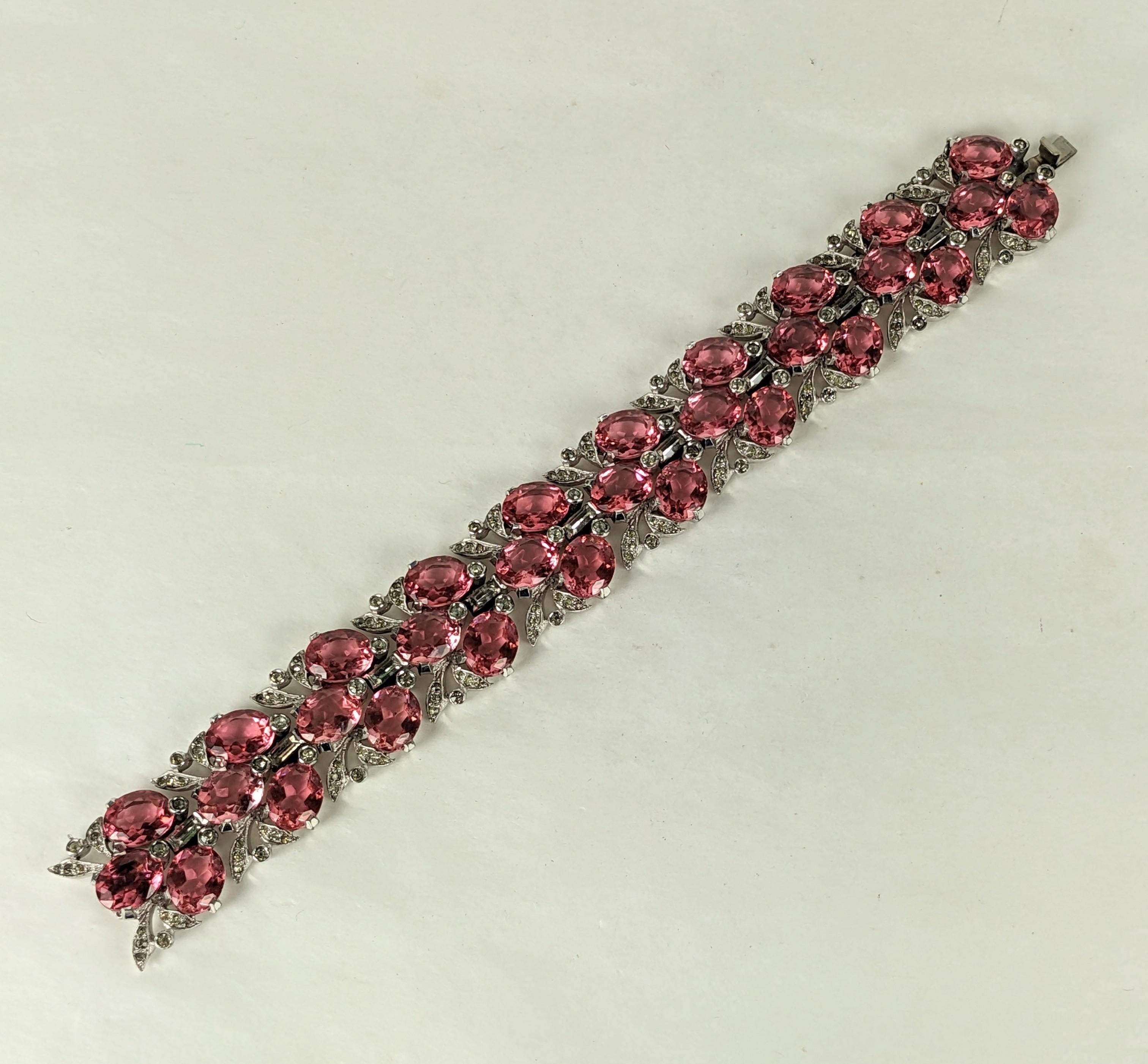 Elegant Art Deco Mazer Pink Wide Bracelet from the 1930's. Pink oval pastes are set within delicate pave leaves in this articulated period bracelet. 
Unsigned. 7