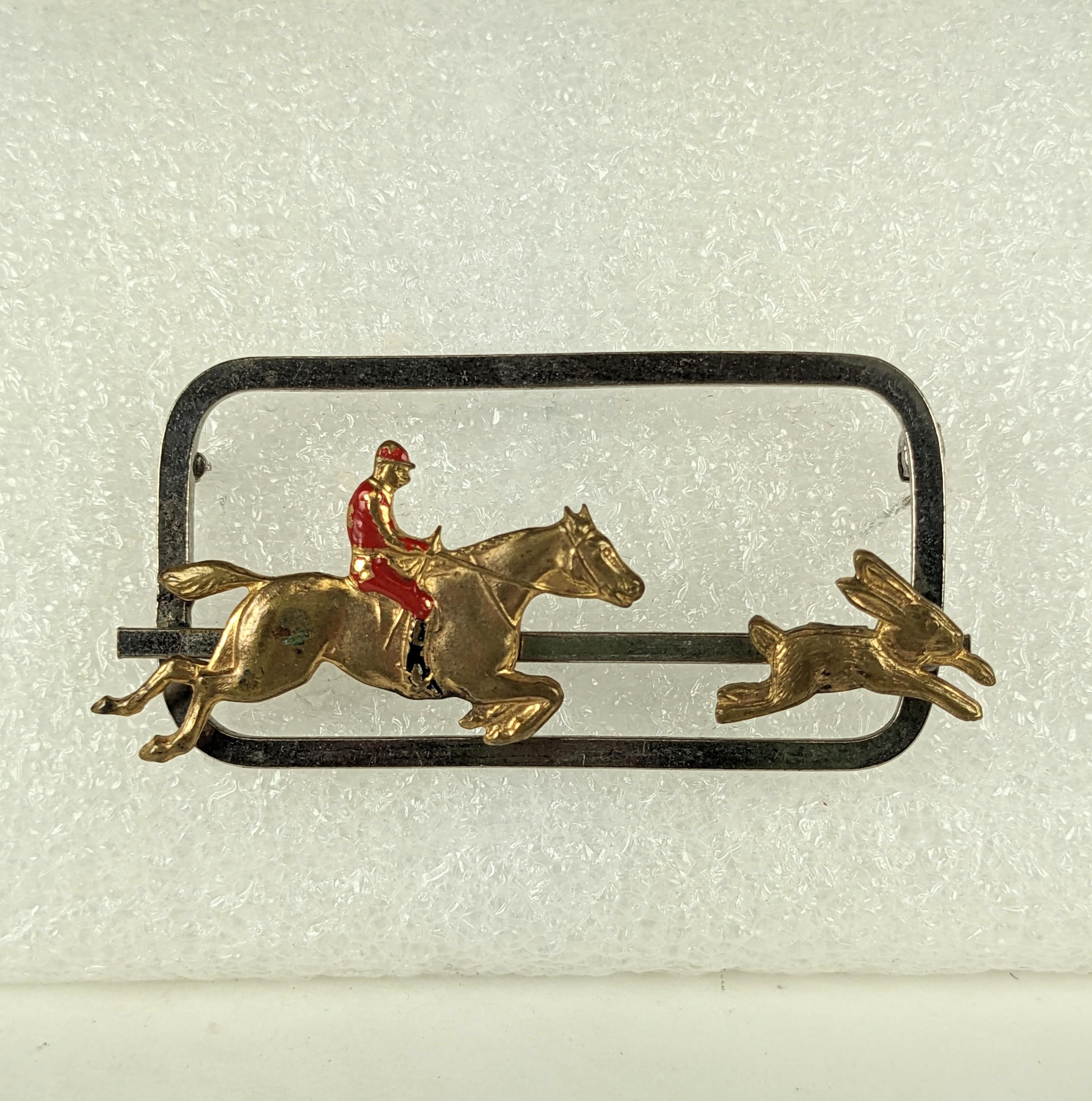 Charming Art Deco Mechanical Hunting Brooch from the 1920's. Rider and bunny slide on a track so brooch can be worn with different positions. Chrome and gilt metal with enamel. Unusual design. 
2.5
