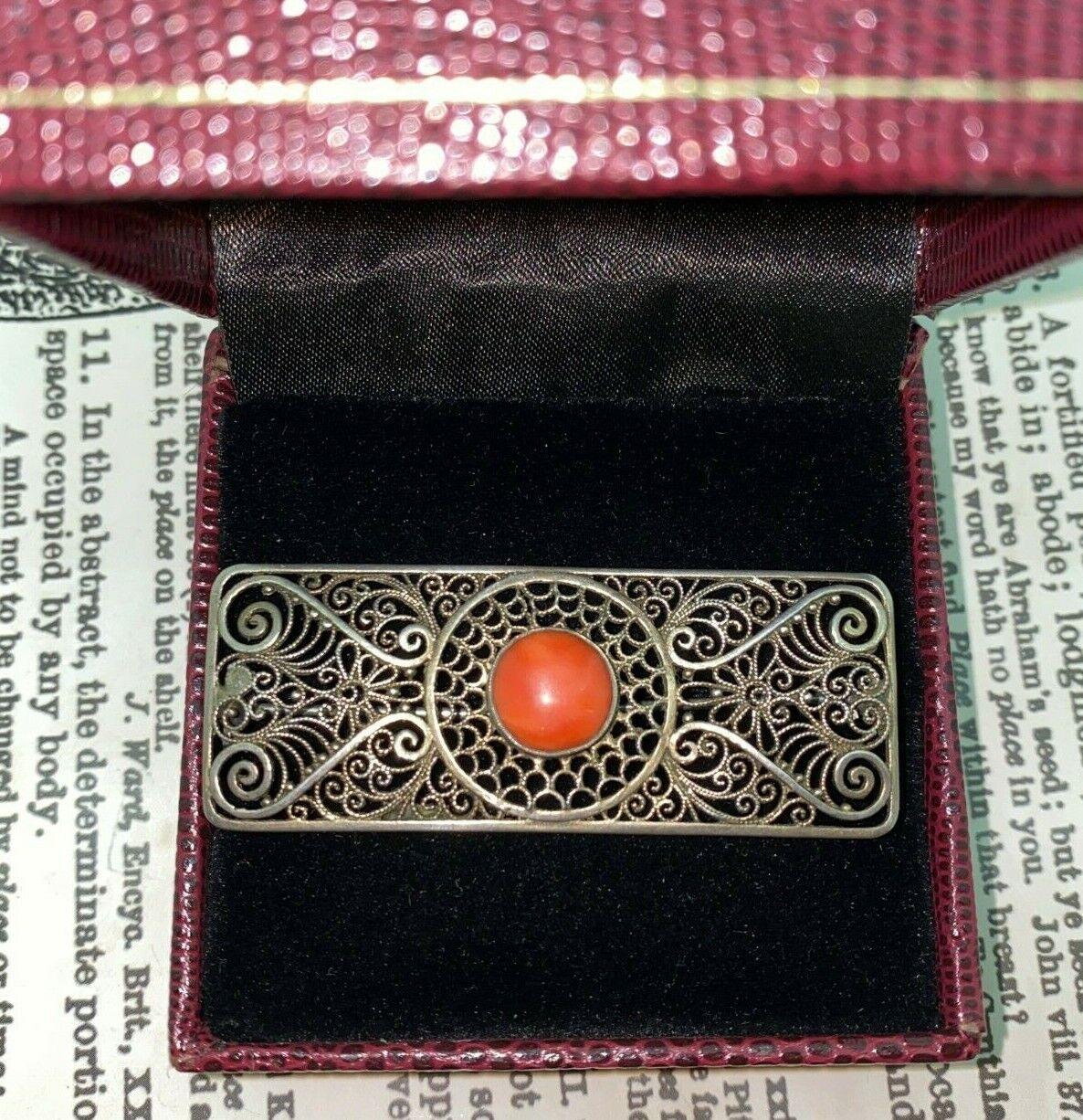 Of French provenance, 
this brooch dates from an Art-Deco (circa 1940's) period 

of filigree design - astonishing in its intricacy 
the piece is centrally set with a Natural Mediterranean Red Coral of 10mm 
of Cabochon Cut 

835 Silver Continental