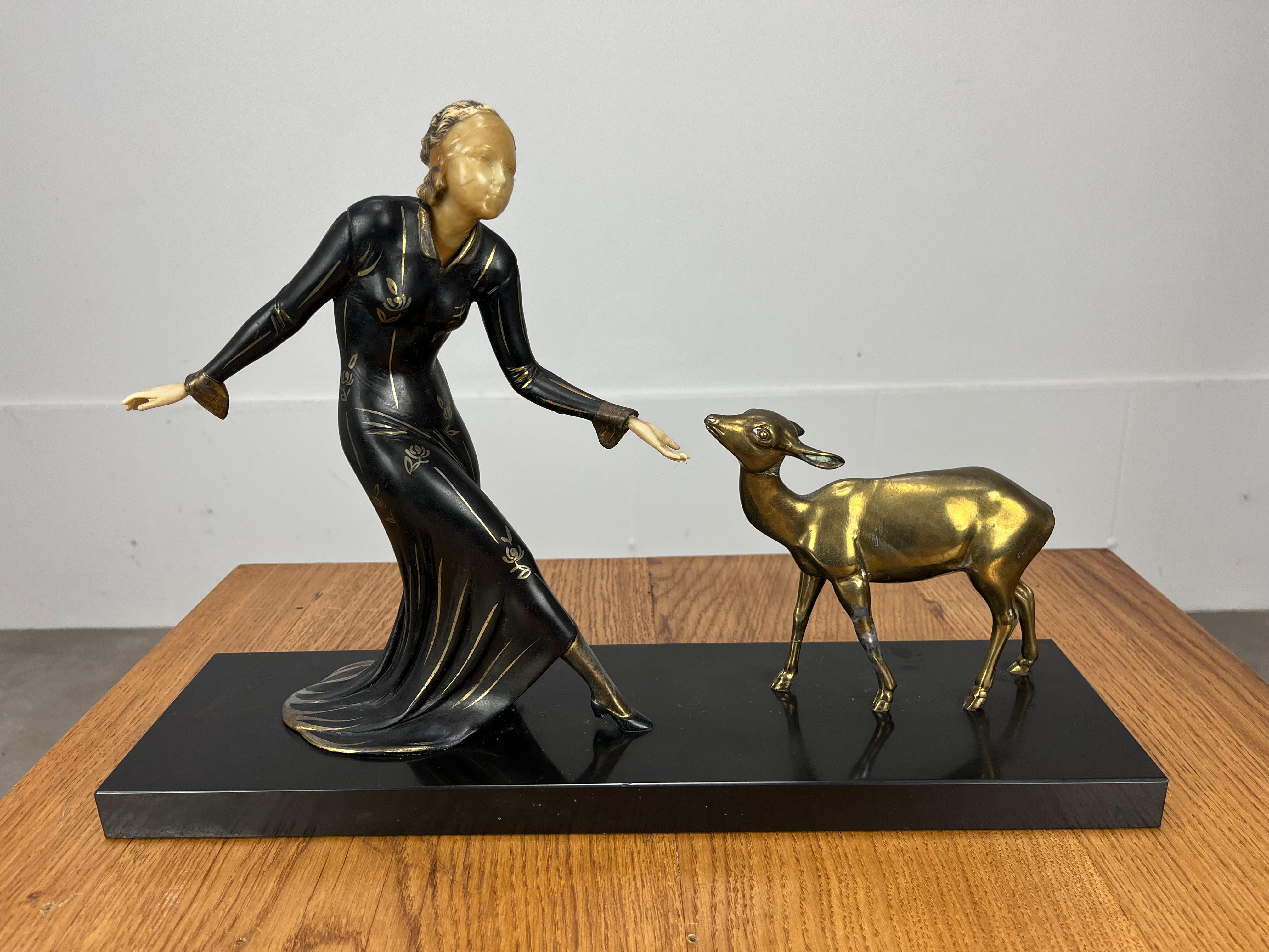 Large French Art Deco sculptural group showing a woman and a fawn, made of patinated metal and imitation of ivory. The figure of the woman was designed by Ugo Cipriani (whose pseudonym is Menneville) and the fawn by Irenée Rochard. 

Irénée Rochard