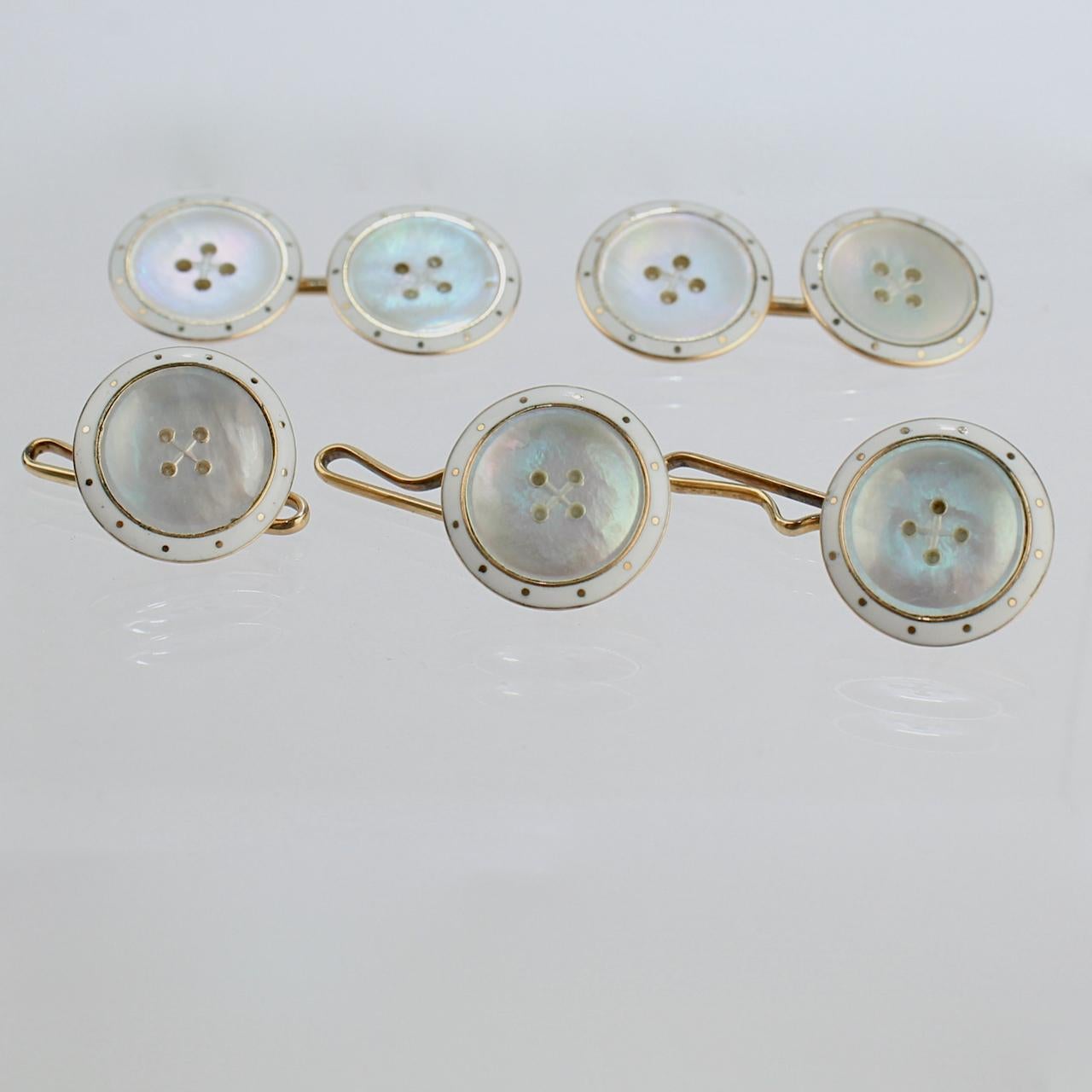 A very fine vintage Art Deco dress set.

Comprising a pair of cufflinks and three dress button in 14k yellow gold with mother of pearl and white enamel decoration.

Each decorated as faux buttons. 

Simply a terrific set for the smartly dressed