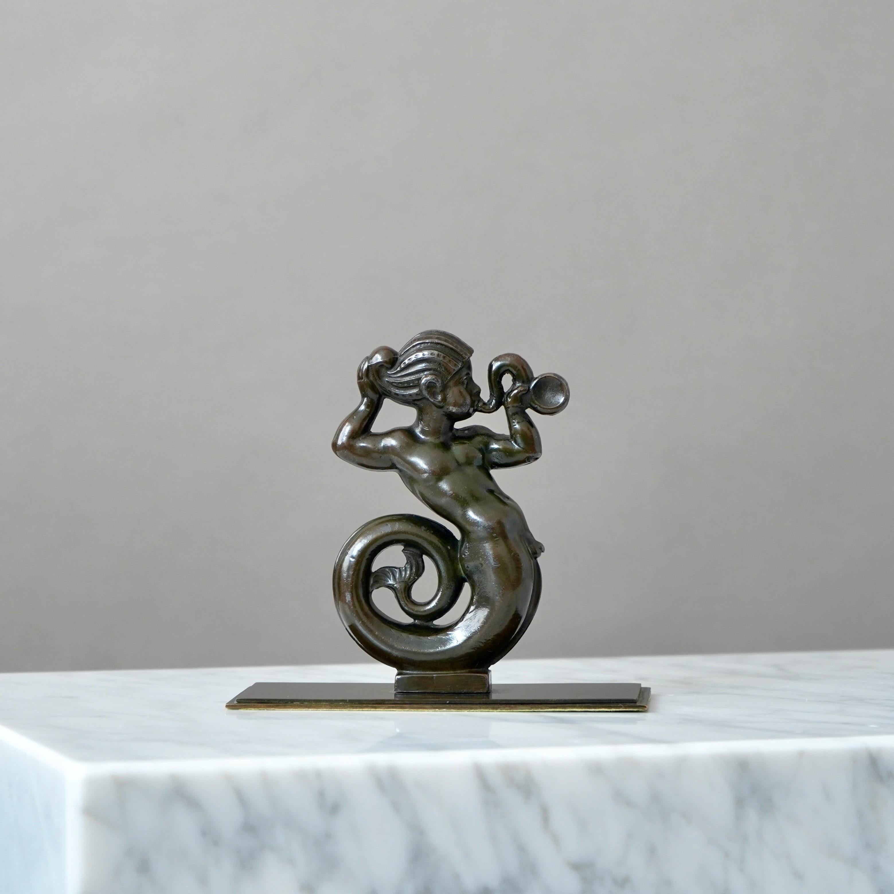 A beautiful art deco merman sculpture, designed by Just Andersen in 1930s and produced by his own company in Denmark. Made from Disko metal (an alloy of different metals invented by Just Andersen).

Good condition. Some light scuffs and