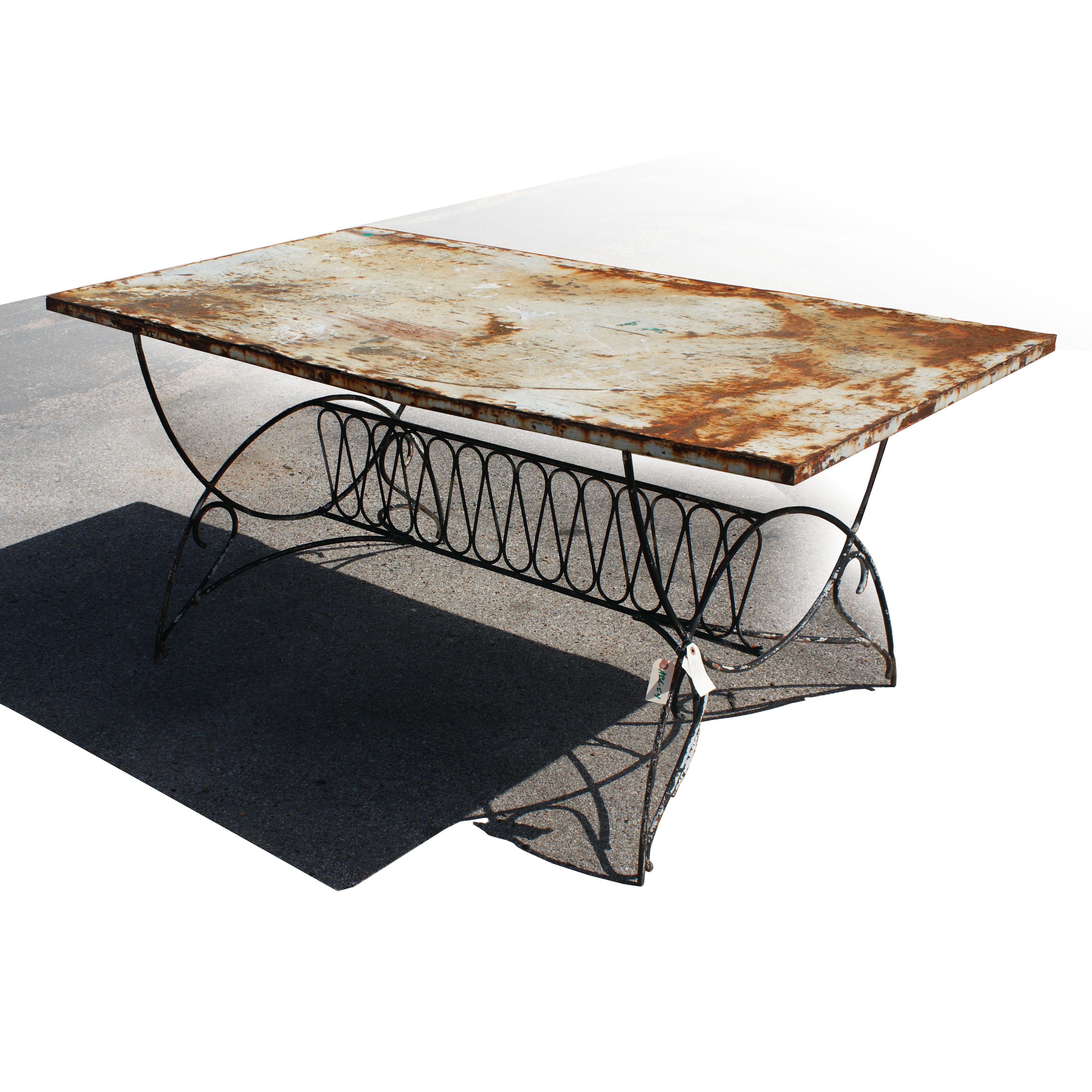 A wonderful Art Deco outdoor table with graceful iron base and unique top with a perfect rustic patina.  This table can be powder coated at an additional cost.