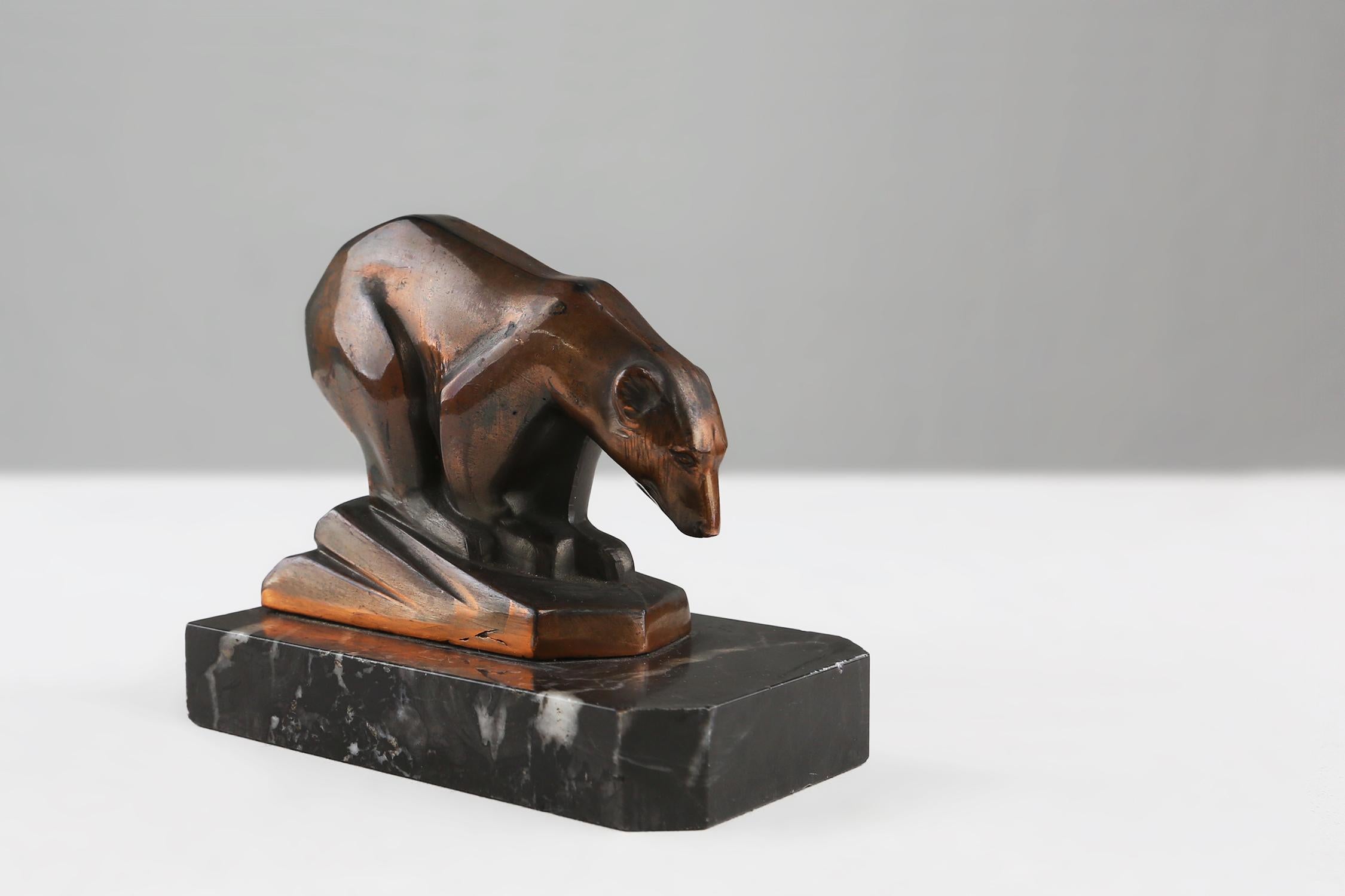 This beautiful Art Deco polar bear figurine is a masterpiece of craftsmanship and design. Made of high-quality Metal, this statue has a beautiful brown patina that shows off the elegance and finesse of the polar bear.

It stands on a black marble