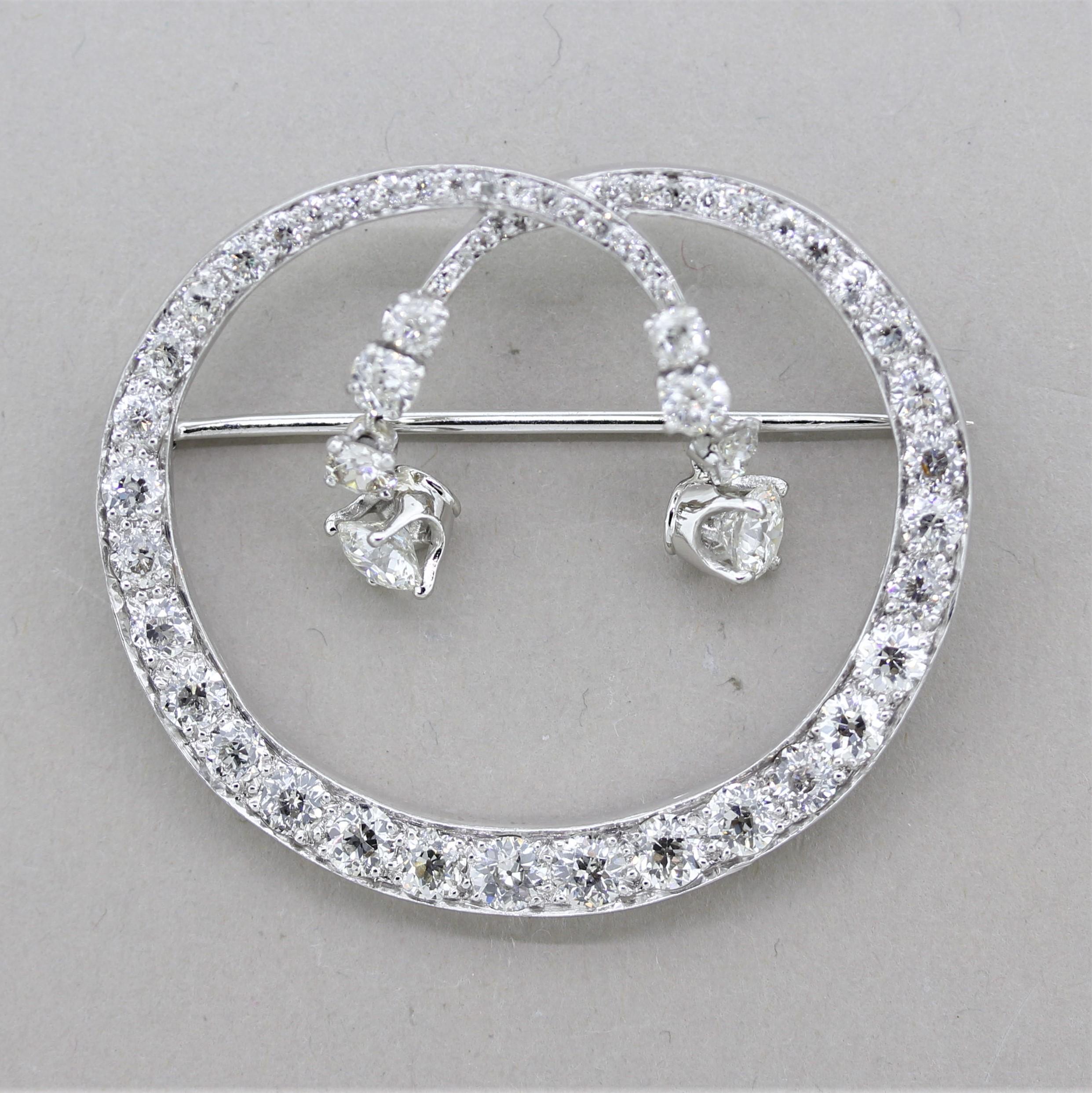A lovely platinum piece originally from the 1930’s Art Deco period which was later modified with two round brilliant-cut diamonds in the 1950’s. It features approximately 6 carats of European-cut diamonds set all around the brooch along with two
