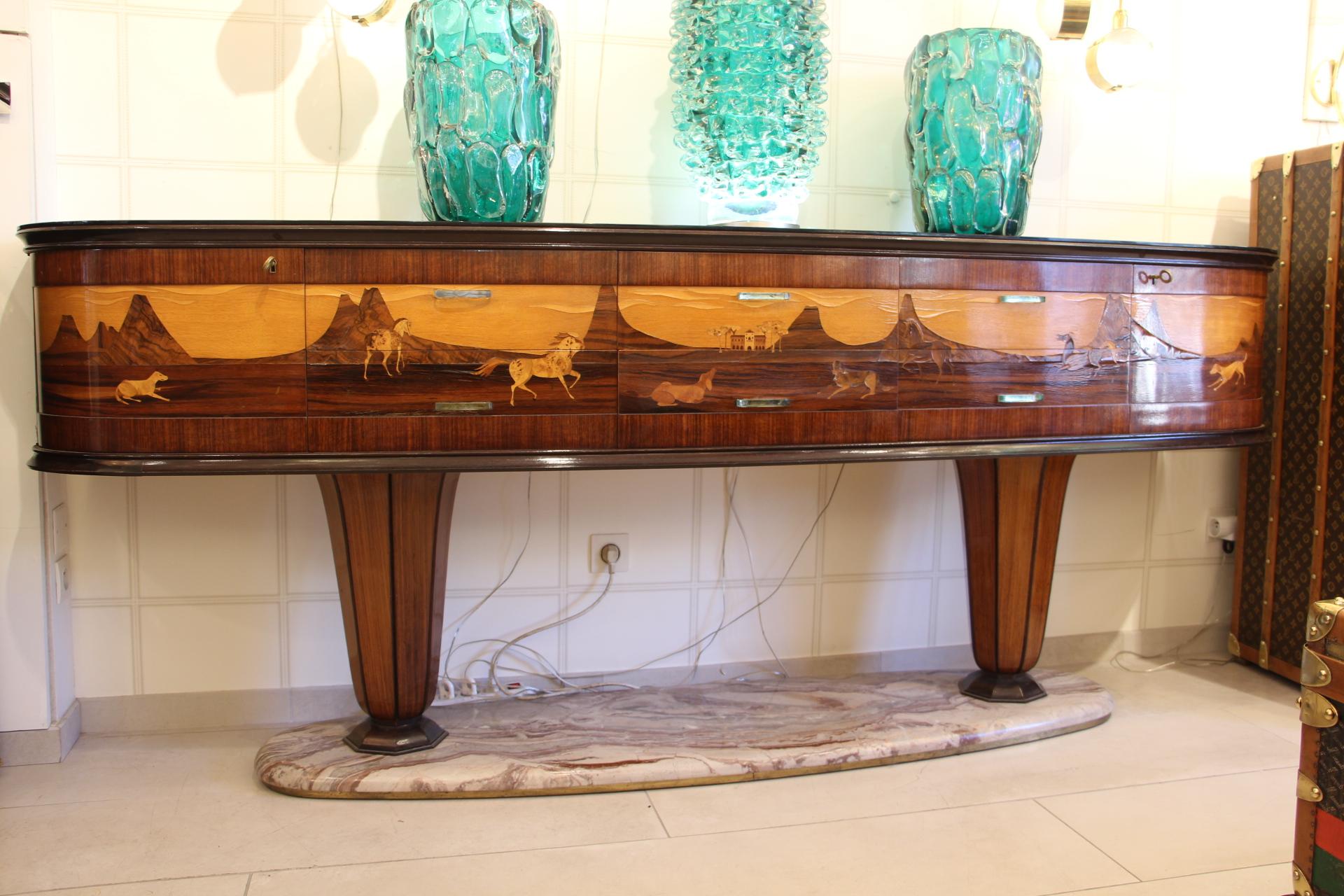Spectacular and very rare sideboard created by Vittorio Dassi in the 1940s.
At the end, it features two curved doors and in the center there are 3 columns of 2 drawers, so a total of 6 drawers. Each drawer has got Murano Glass handle.
 Externally