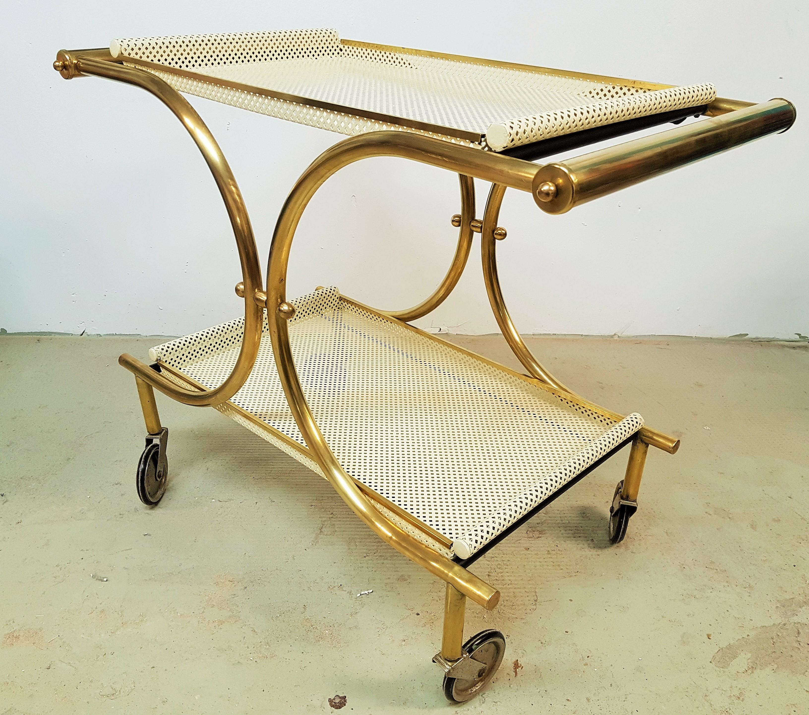 Art Deco midcentury Matégot style Art Deco bar cart 1940s, brass and ivory lacquer. Very good vintage condition. Castors work perfectly.