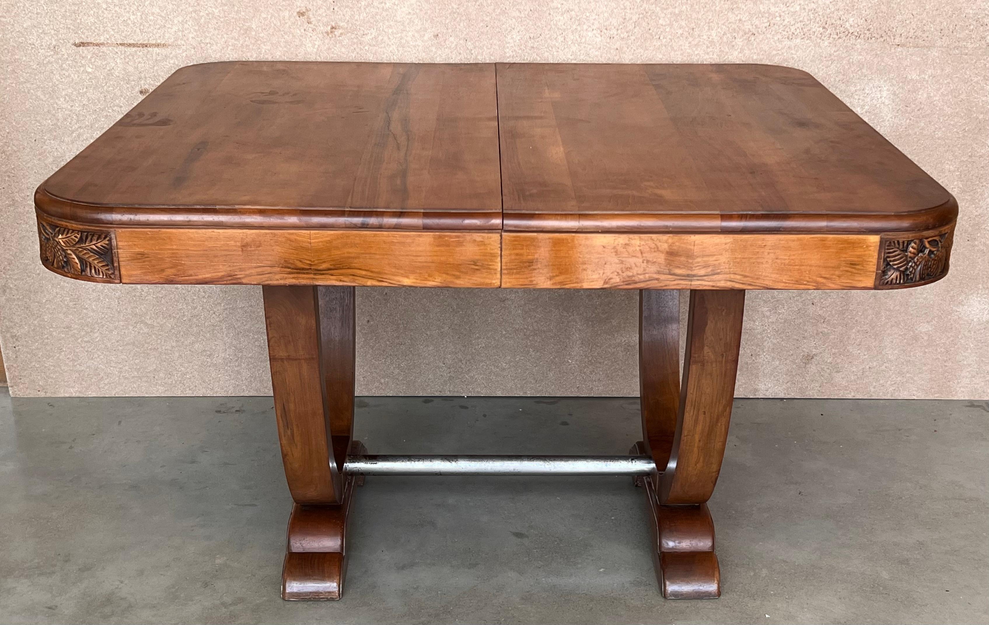 Fabulous custom made walnut dining table which extends Table is 41.3 in x 46.65 in without the leafs which mount to the center seamlessly. Custom made 60 yrs. ago and in magnificent condition. Very solid table with beautiful graining. Arched