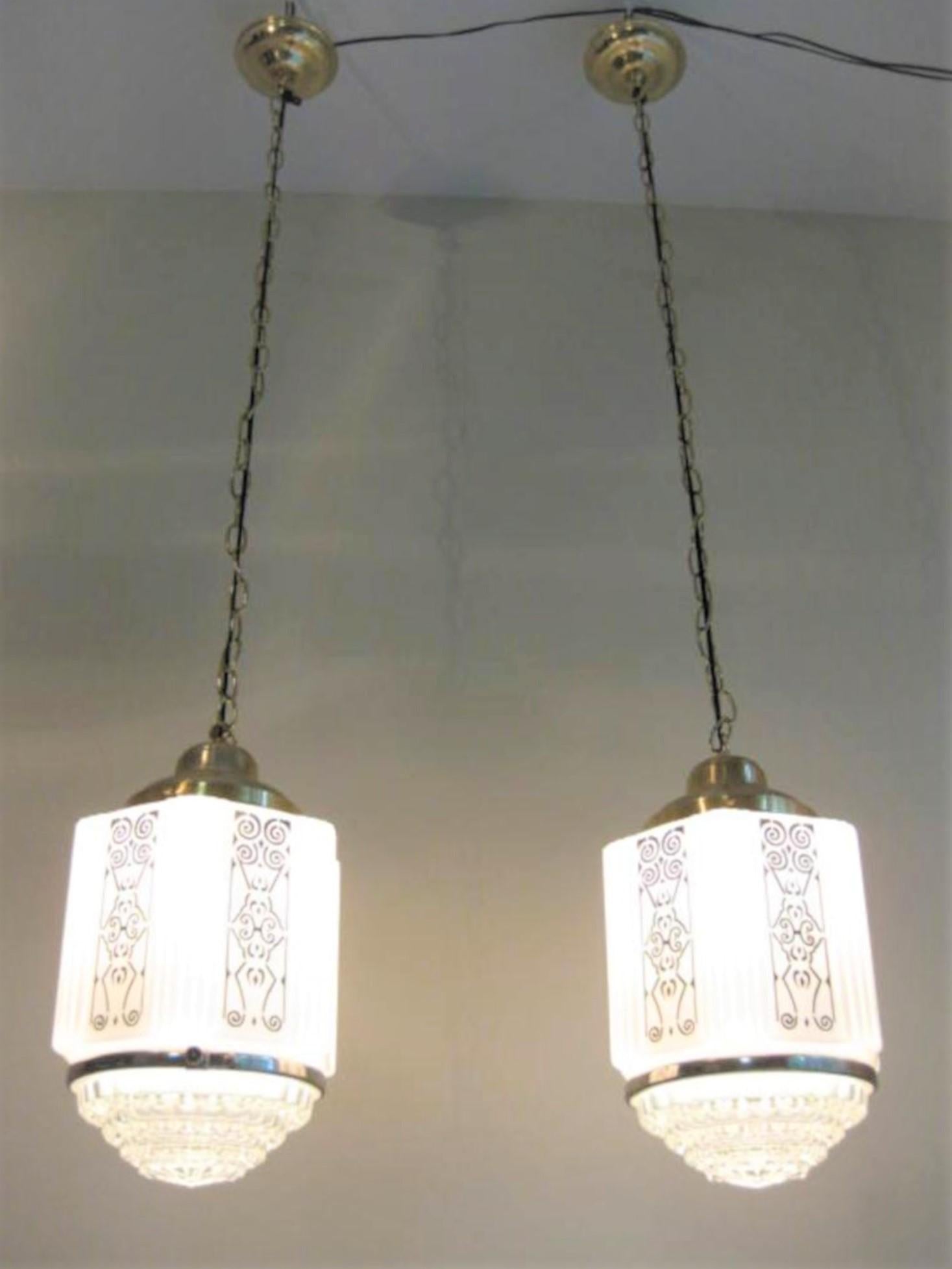 Antique Art Deco black stencil on milk glass is perfectly intact with no scratches. Clear decorative glass on bottom. Original chrome attachment which displays original patent number. Brass plated hanging hardware is newer with recent wiring.