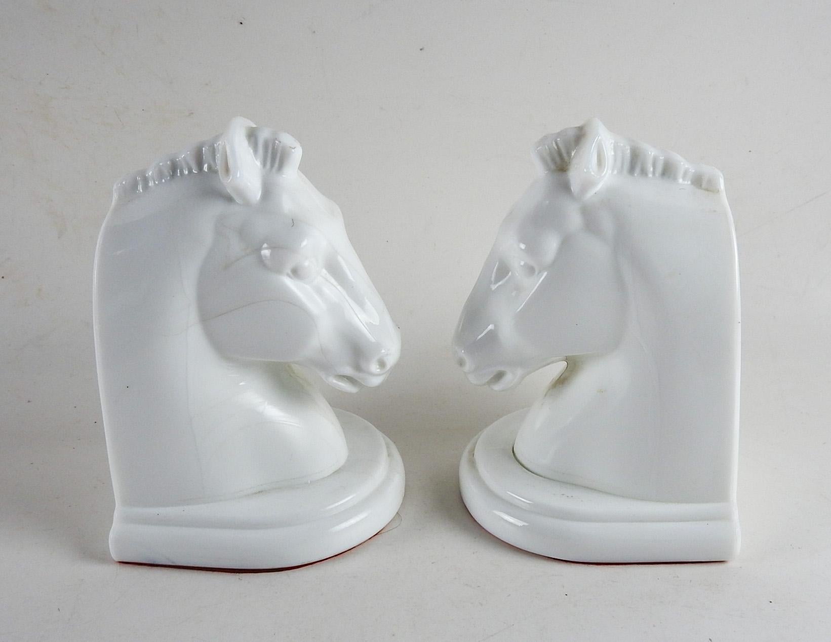 Pair of vintage milk glass horse head bookends.  Great look, heavy with red felt on the bottoms.