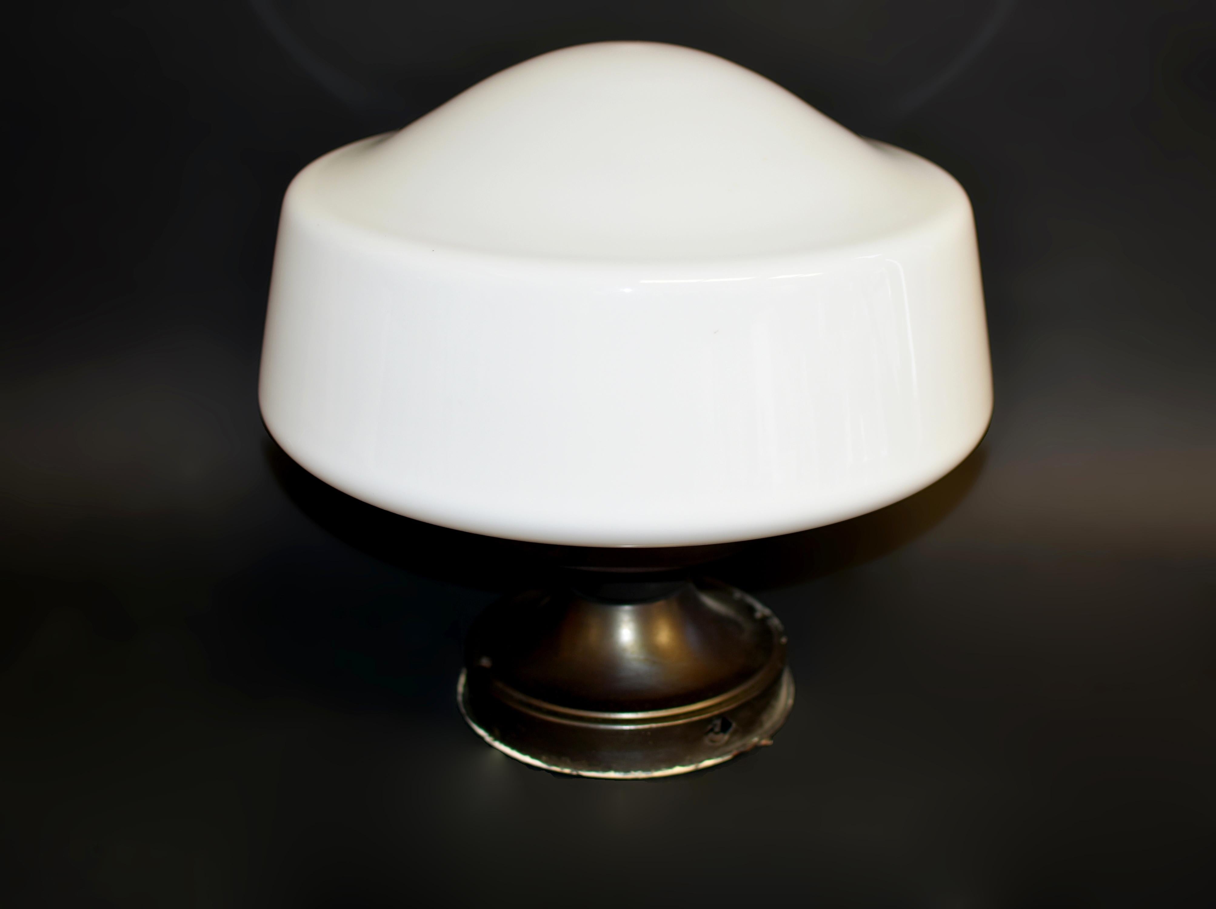 This is an original, authentic Art Deco white milk glass light shade, showcasing the elegance and craftsmanship of the era. The glass remains in remarkable condition, preserving its original charm. Its graceful form and clean lines reflect an