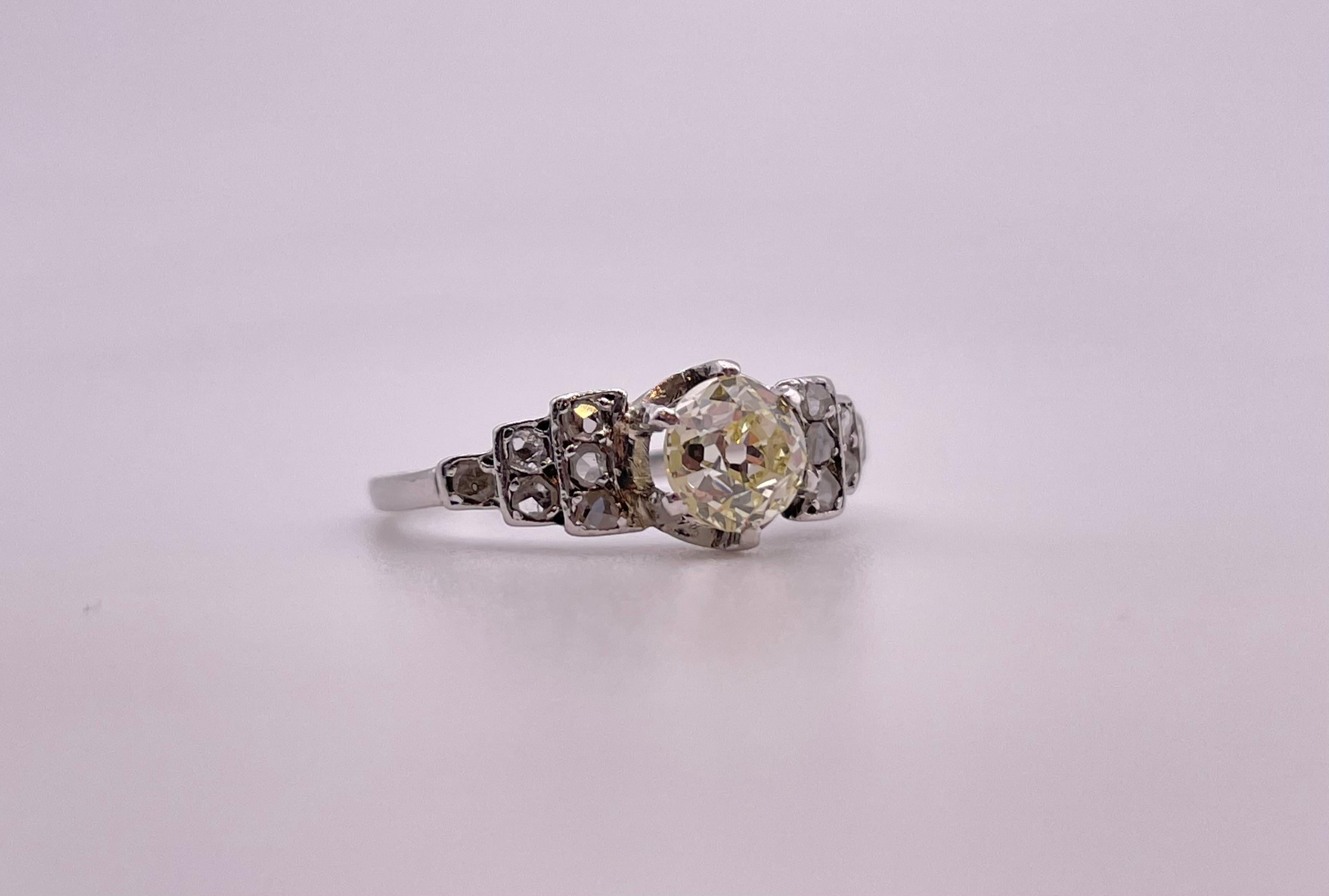 This is a stunning and dramatic Antique Art Deco Old Mine Cut Diamond Ring in White Gold with a gorgeous central 0.90 Carat Old Mine Diamond . 
The central Diamond surrounded by 12 smaller Old Mine Cut Diamond set on the mount . 
color : K
clarity :
