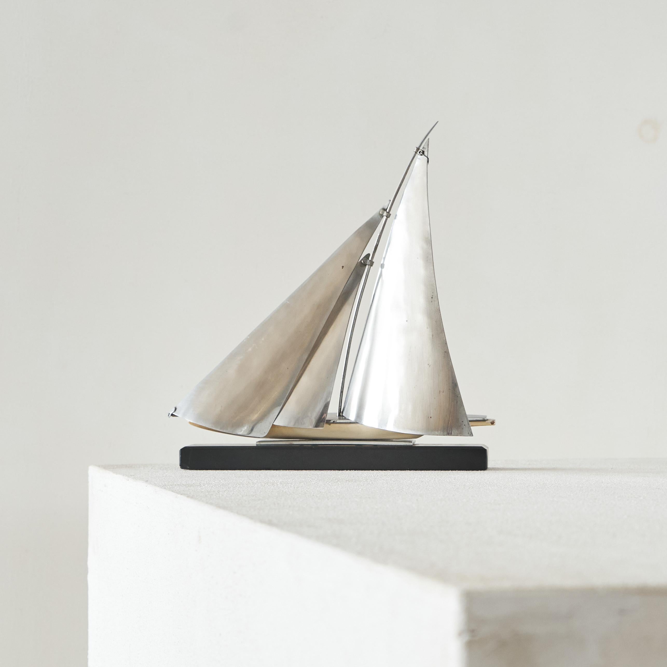Art Deco Style Miniature 'Dragon' Sailing Boat. Europe, mid to late 20th century.

A wonderful miniature sailing boat - very refined and semi-abstract. Wonderful details and appearance. Great on a desk or in a cabinet. 

The Dragon is a one-design