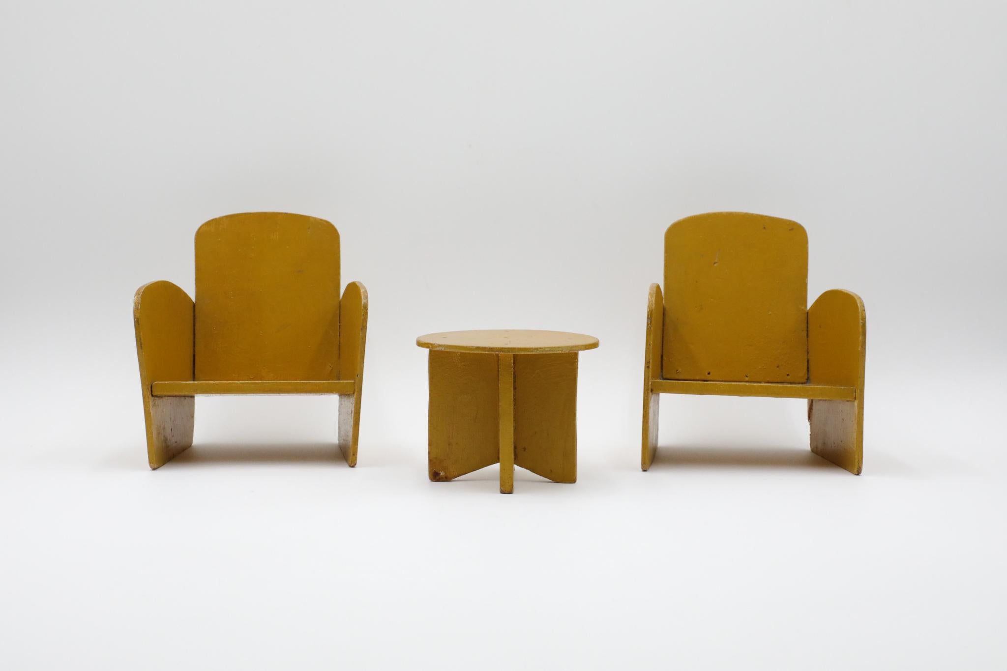 Lovely Art Deco miniature yellow painted wood lounge chair and side table furniture set. The chairs are 5.75 x 6.25 x 6.5, table is 4.375 x 3.75 x 3.5. In lovely original condition with heavy patina and age appropriate signs of wear.