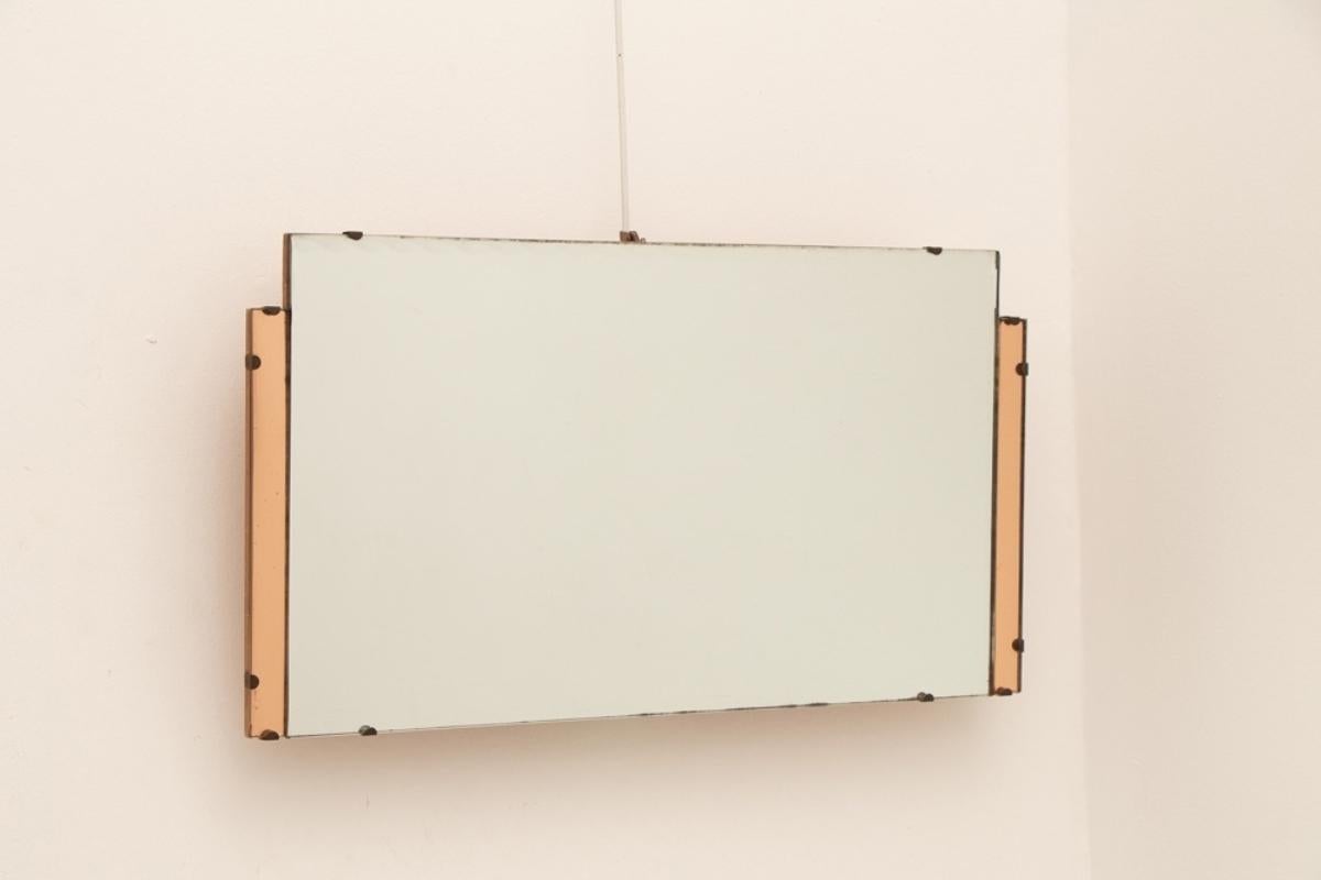 A rectangular Art Deco mirror with peach coloured side panes.