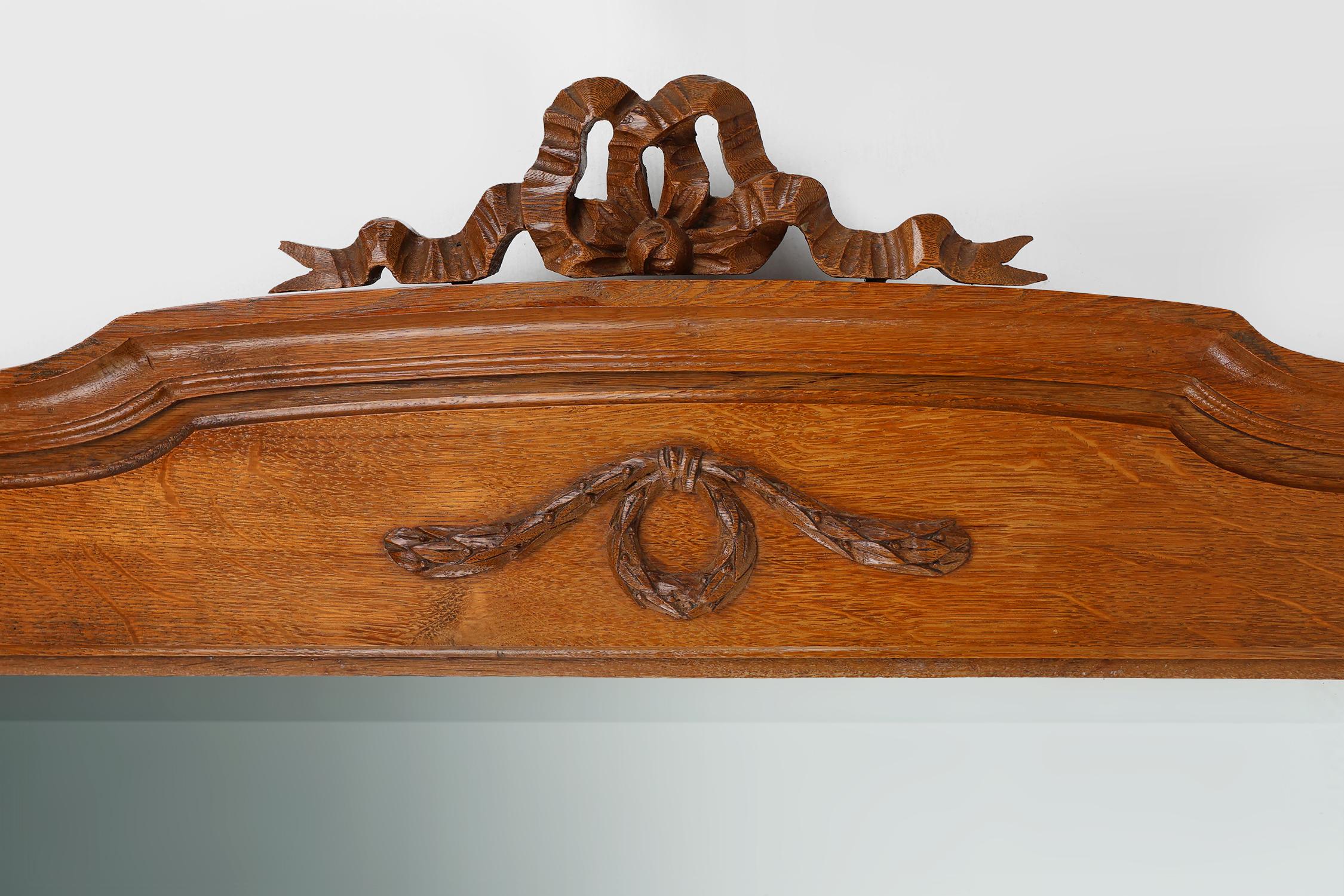 French Art Deco mirror in oak with carved decorations and facet cut mirror, 1930s For Sale