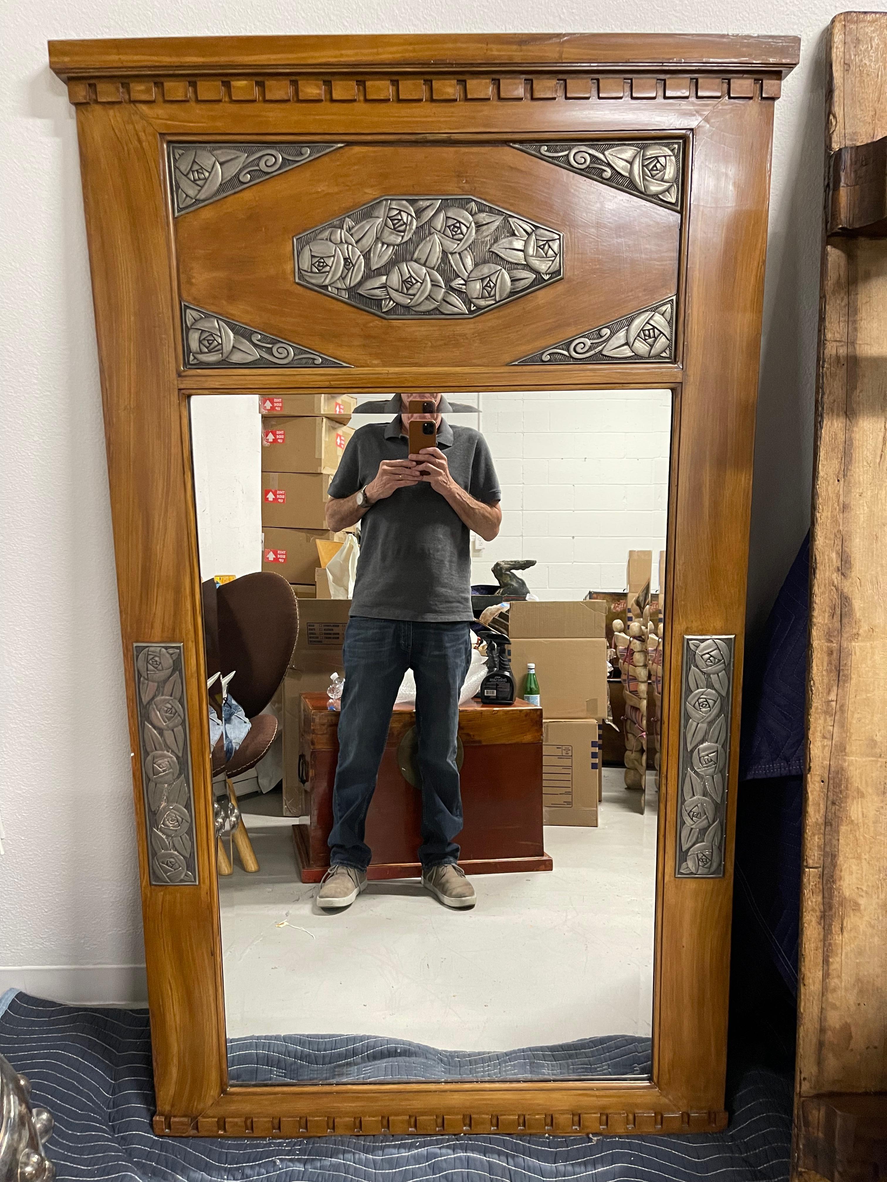 A pretty Art Deco Mirror in the style of Sue Et Mare. This was in the great room of an elegant Palm Springs estate. The mirror is period Art Deco. Please see the detailed photos of the back and it’s age. The mirro has likely been refinished, and is