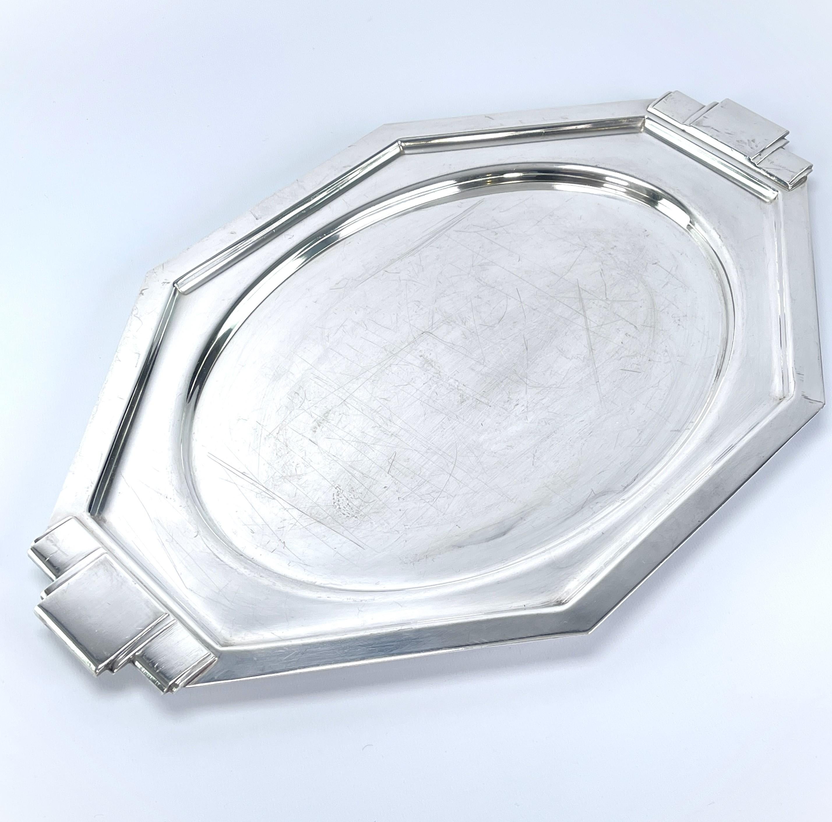 ART DECO Tray silver plated, 1930s

This beautiful, silver-plated tray from the 1920s is in the streamline modern Art Deco style. This style emphasised curvy, streamlined shapes. The tray still impresses with its beautiful shape.
The tray is marked.