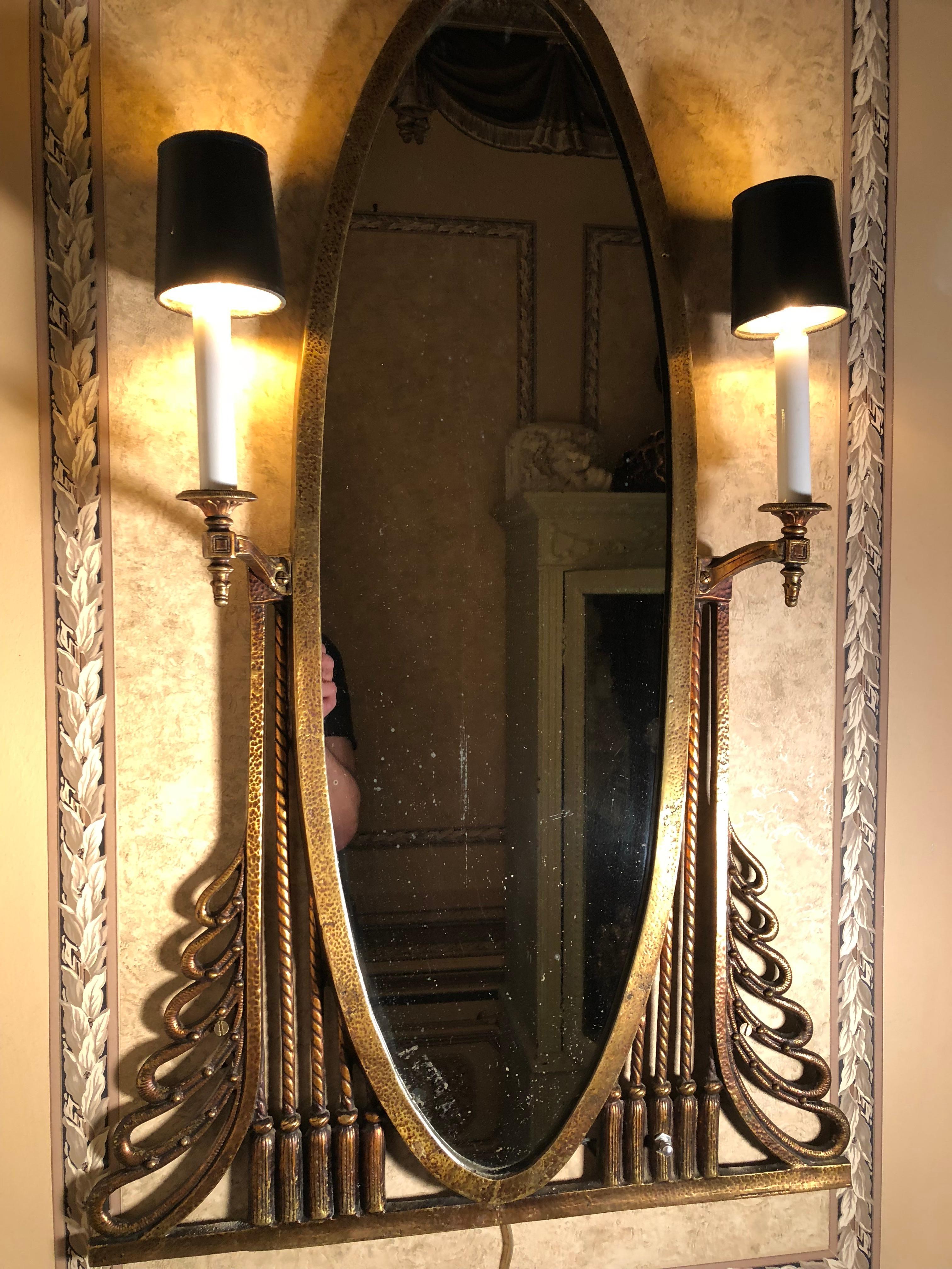 Absolutely Art Deco, this beautiful heavy bronze oval mirror detail and Classic lines of Art Deco. Designed by Oscar Bach (German 1884-1957} it retains its aged original finish and has been rewired. The mirror is also original with just enough loss