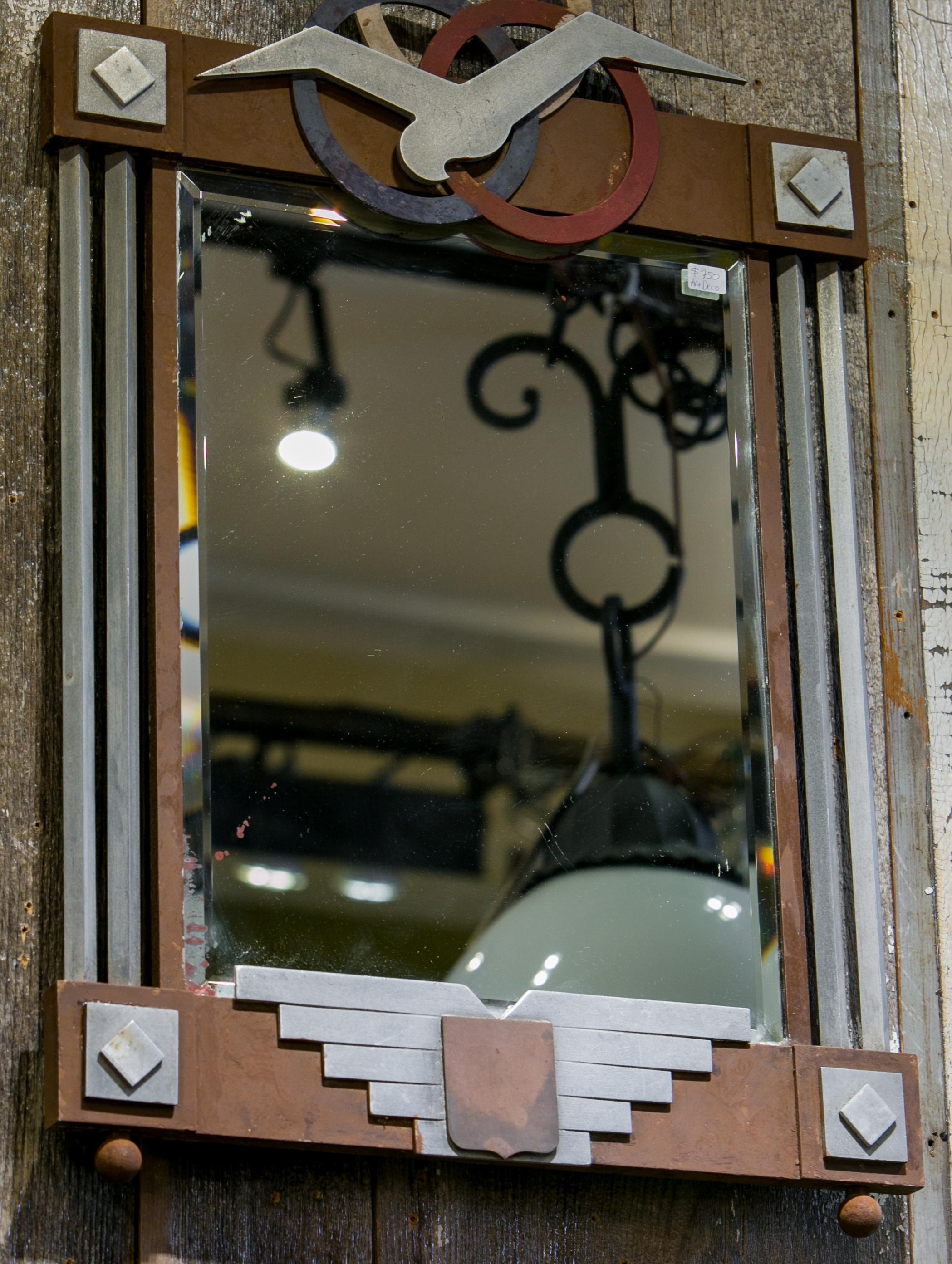 Art Deco mirror with wood and aluminum frame. The mirror is such a classic Art Deco piece. Its colors are silver and oxblood with a bit of blue. The mirror is original and shows some natural distressing.
