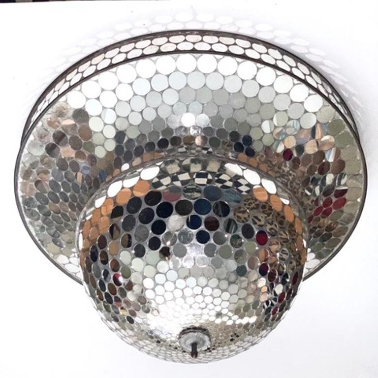 American Art Deco mirrored ball from a 1930s disco roller rink. The piece is made with mirrored discs of various sizes covering a metal frame of unusual shape. In very good vintage condition with age-appropriate wear and use.
