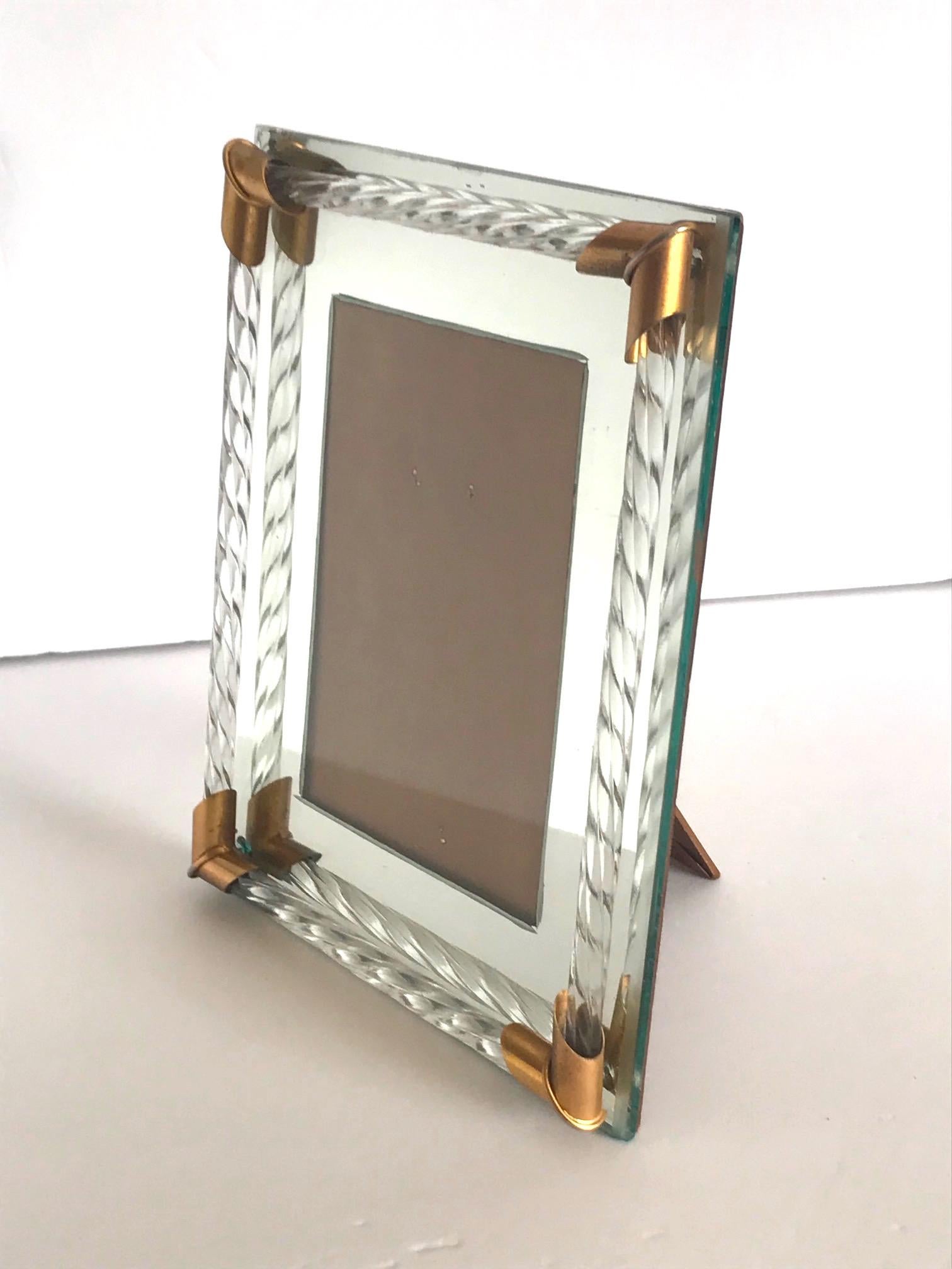 Gorgeous Italian Hollywood Regency mirrored picture frame with Murano glass rods in the form of twisted rope. The picture frame holds a 4