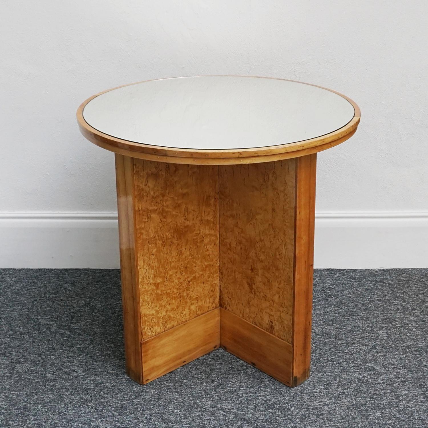 An Art Deco mirrored topped Centre Table. Karlian birch veneered with figured walnut banding. Replacement mirrored glass top. 

Dimensions: H 86cm D 91.5cm 

Origin: English

Date: Circa 1935

Item Number: 2704226

All of our furniture is