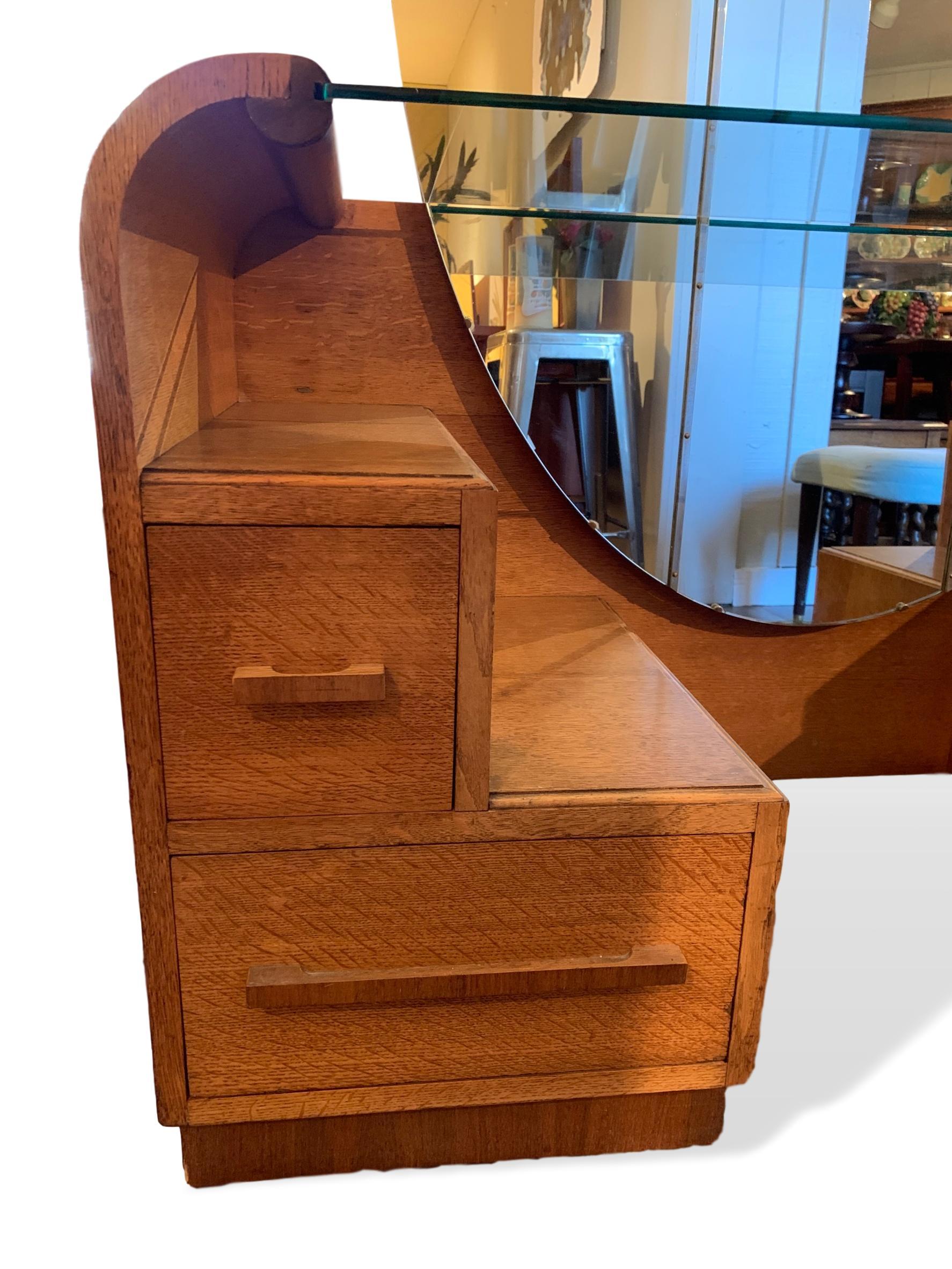 Art Deco golden oak mirrored vanity with drawers manufactured by English Company EG Furniture, 1940s. EG Furniture later became well known for their G-Plan Furniture range. Dresser/Vanity has four storage drawers with the top right having a small