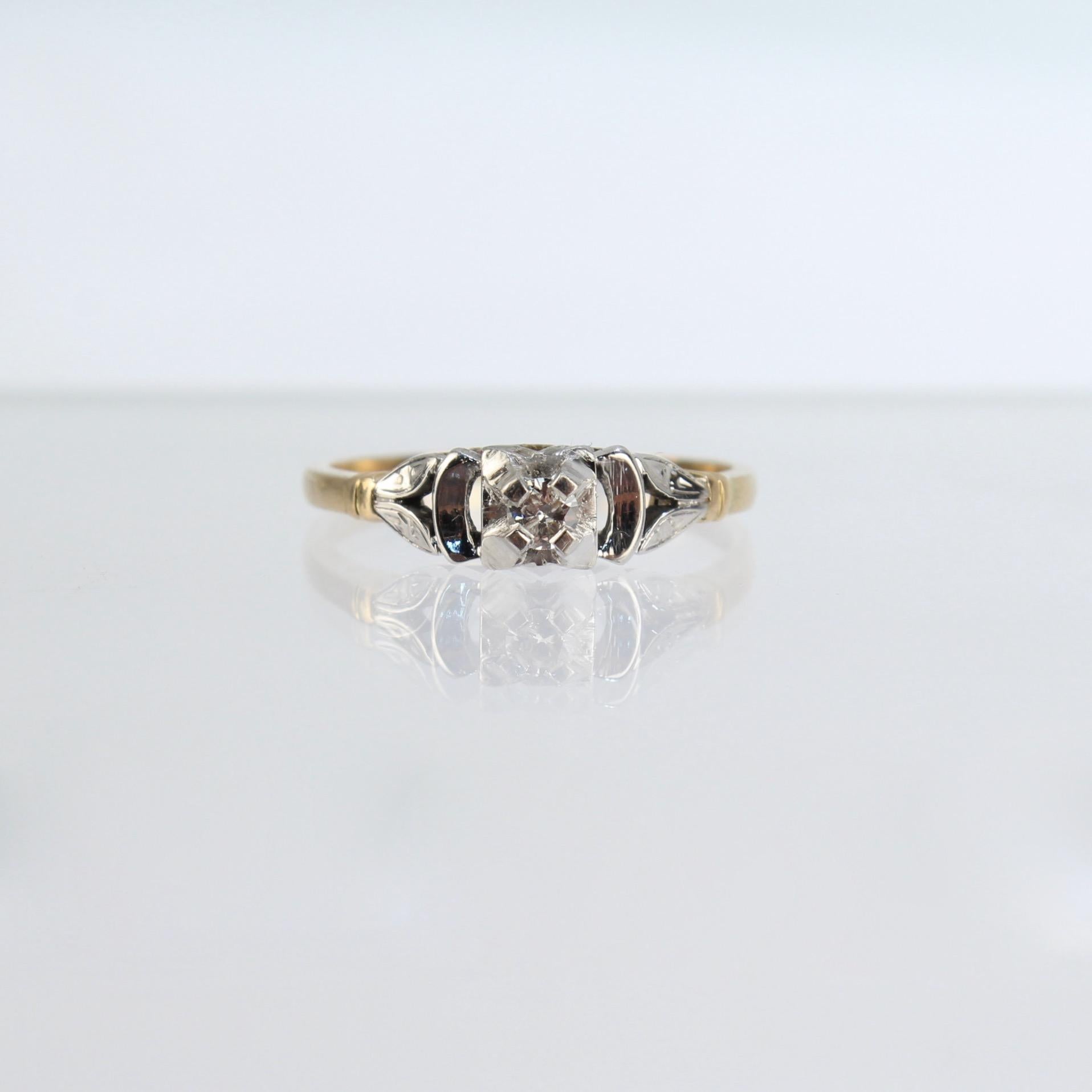 A very fine Art Deco engagement ring.

With a single diamond wonderfully set in a 14k white gold bridge supported by an 18k yellow gold shank.

Great mixed metals Art Deco design!

Date:
Early 20th Century

Overall Condition:
It is in overall good,
