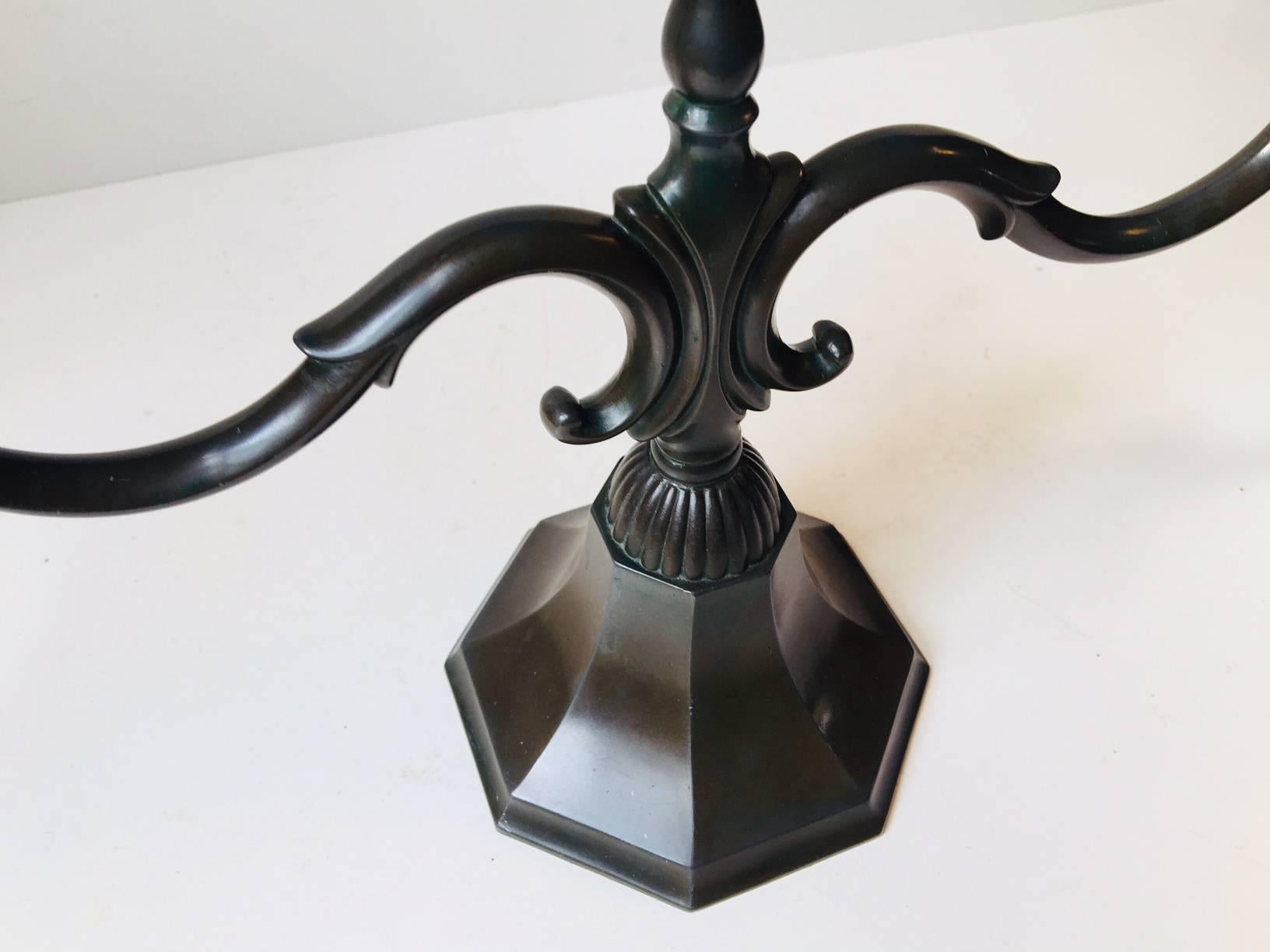 - Large candelabra in disko metal designed by Just Andersen
- Manufactured during the 1930s in his workshop in Copenhagen
- This is model 155 and it features an octagonal base and three arms
- Its stamped and numbered by the maker to the inside