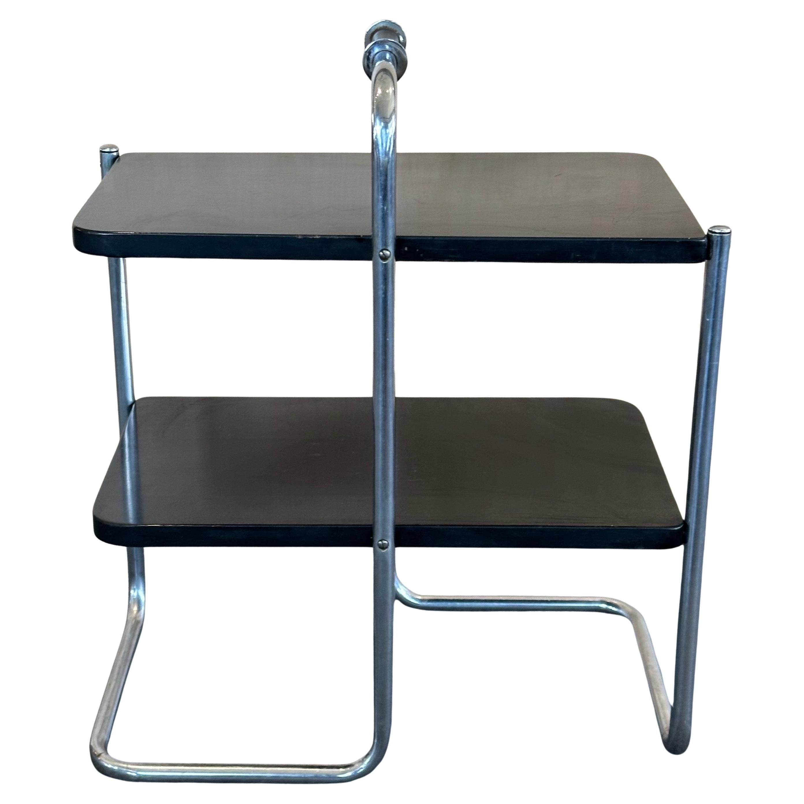 A very rare art deco / machine age Model #305 chrome with black lacquer end table by Wolfgang Hoffman for Howell Co., circa mid 1930's. The table is in fair to good original vintage condition and measures 20.75