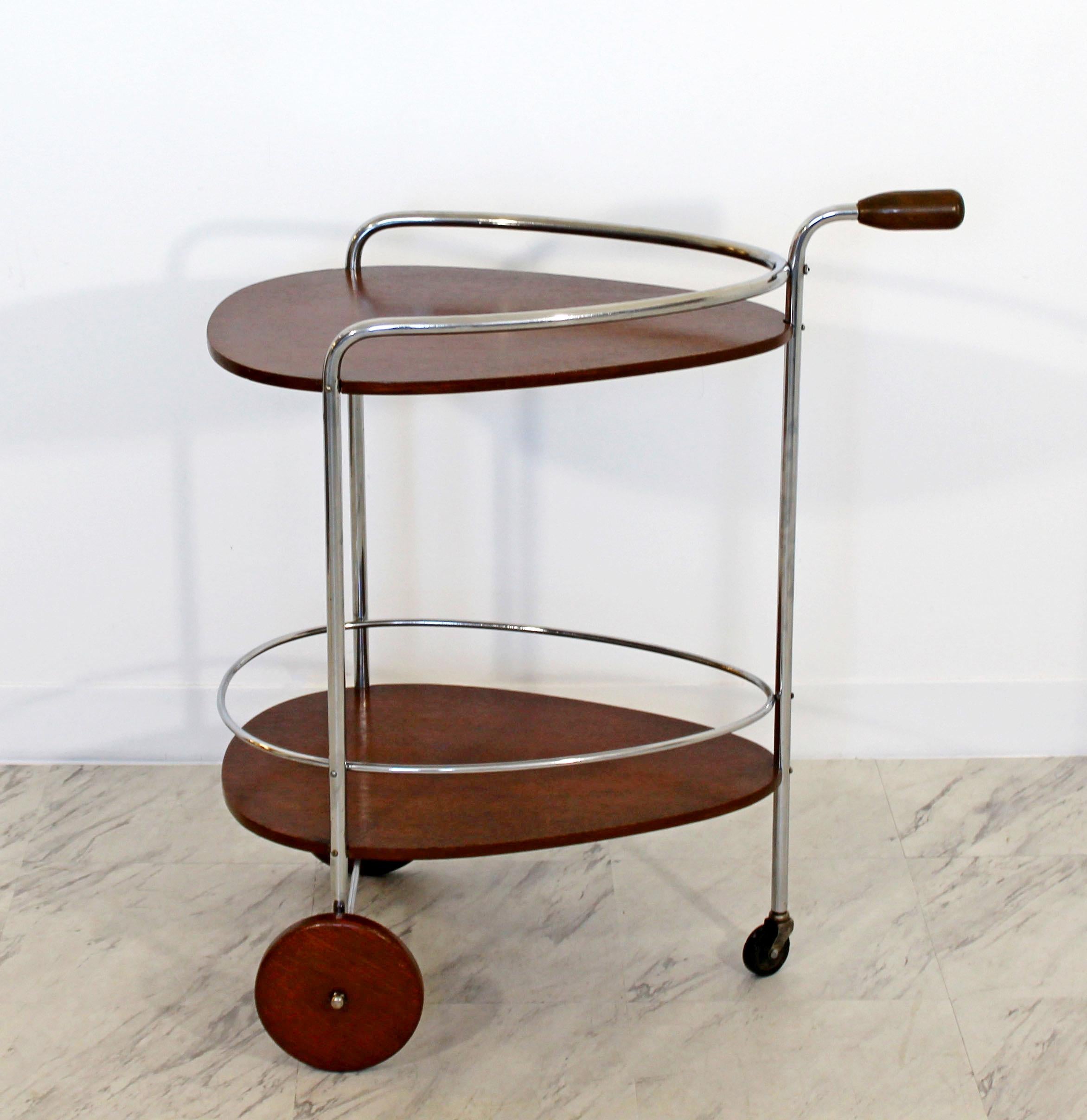 For your consideration is a phenomenal, two tiered bar or serving cart, made of wood and chrome, by Treitel Gratz, circa 1940s. In excellent condition. The dimensions are 26
